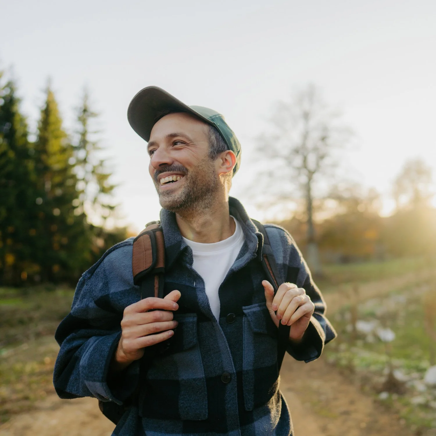 Man in hat spends time outside.