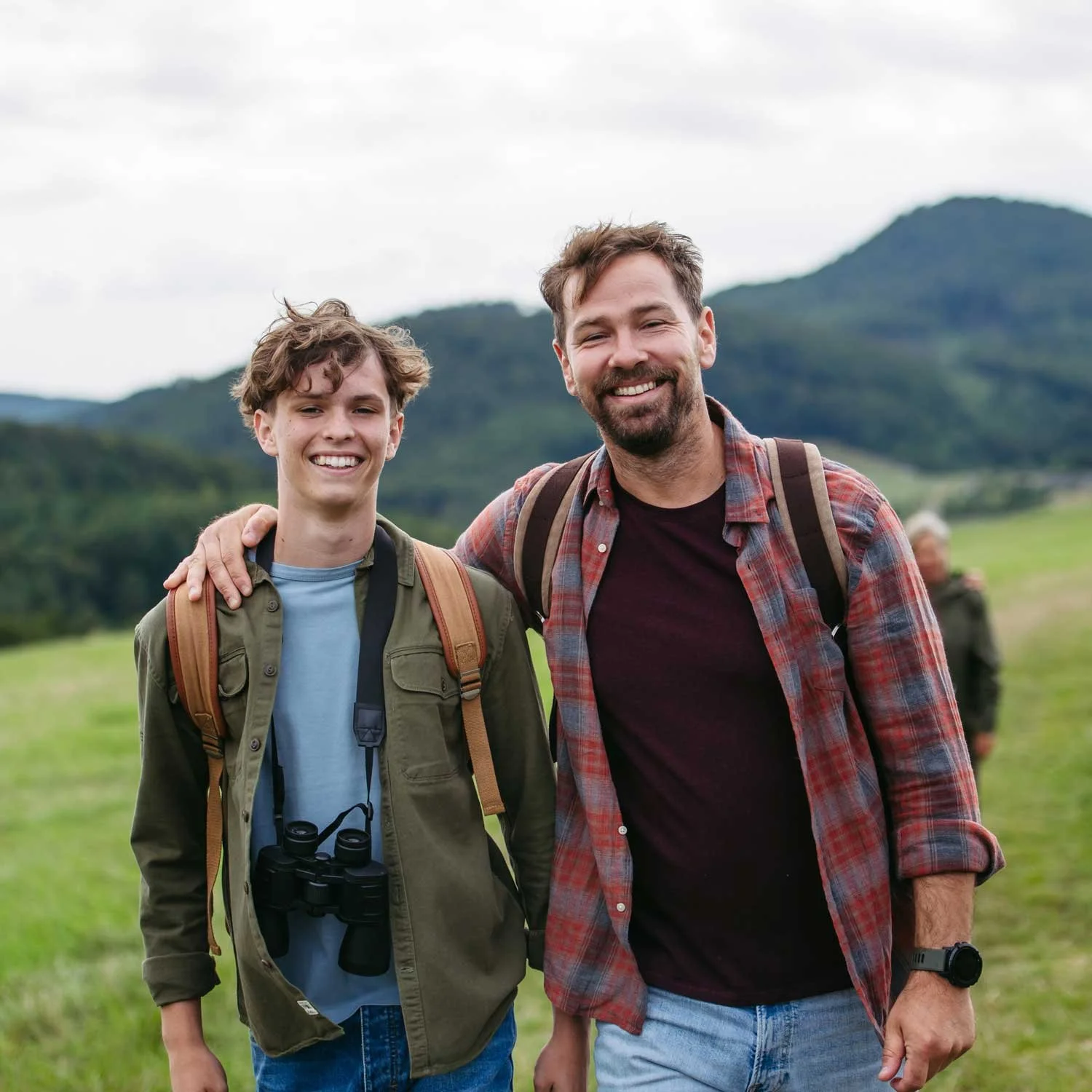 A father and son go for a hike.