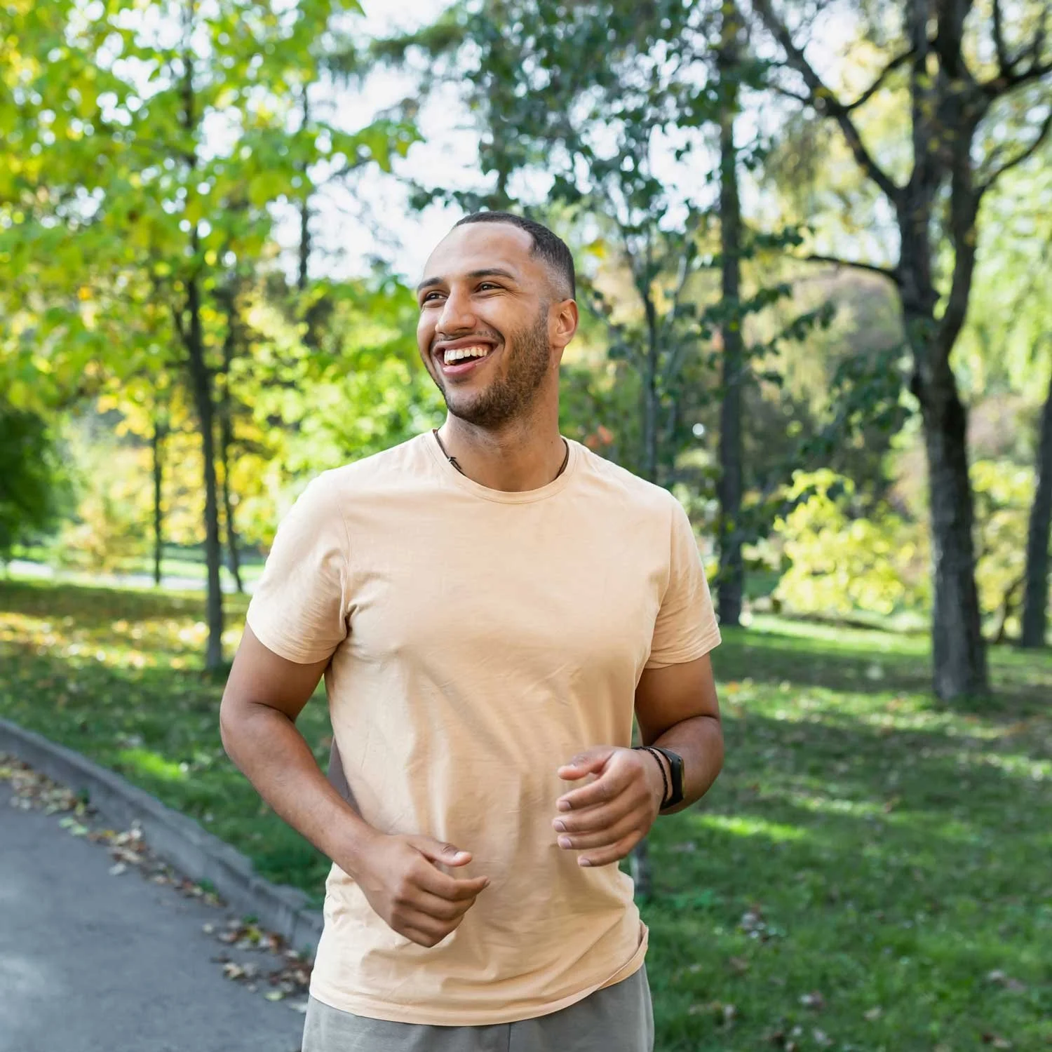 A man exercises outdoors in a park.