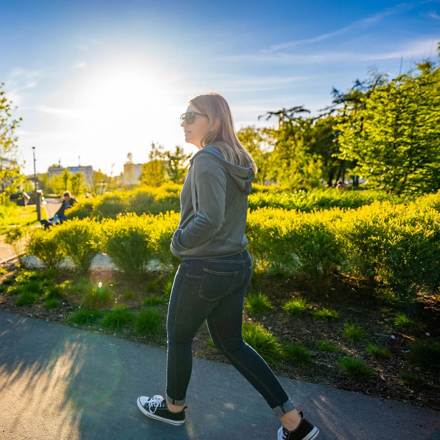 Woman goes for an urban hike through a park.