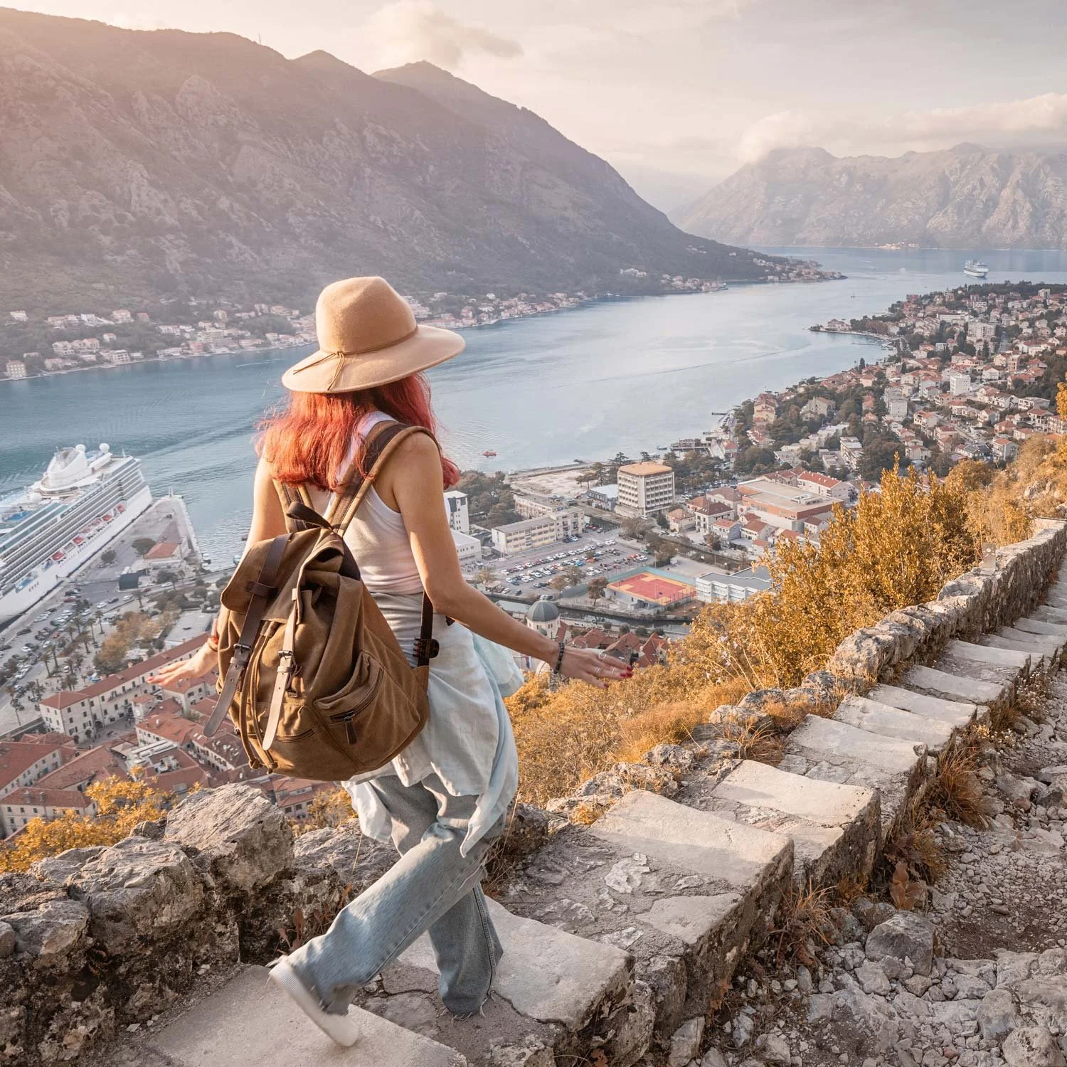 Urban hiker walks down long staircase.