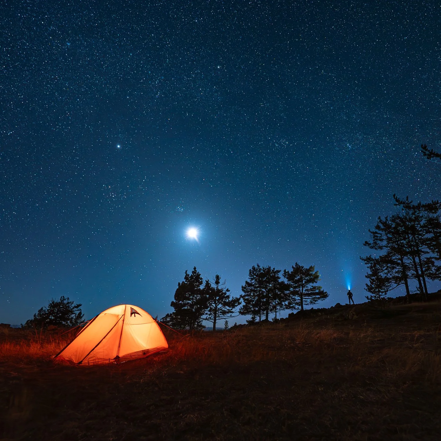 Camping tent at night with stars above.