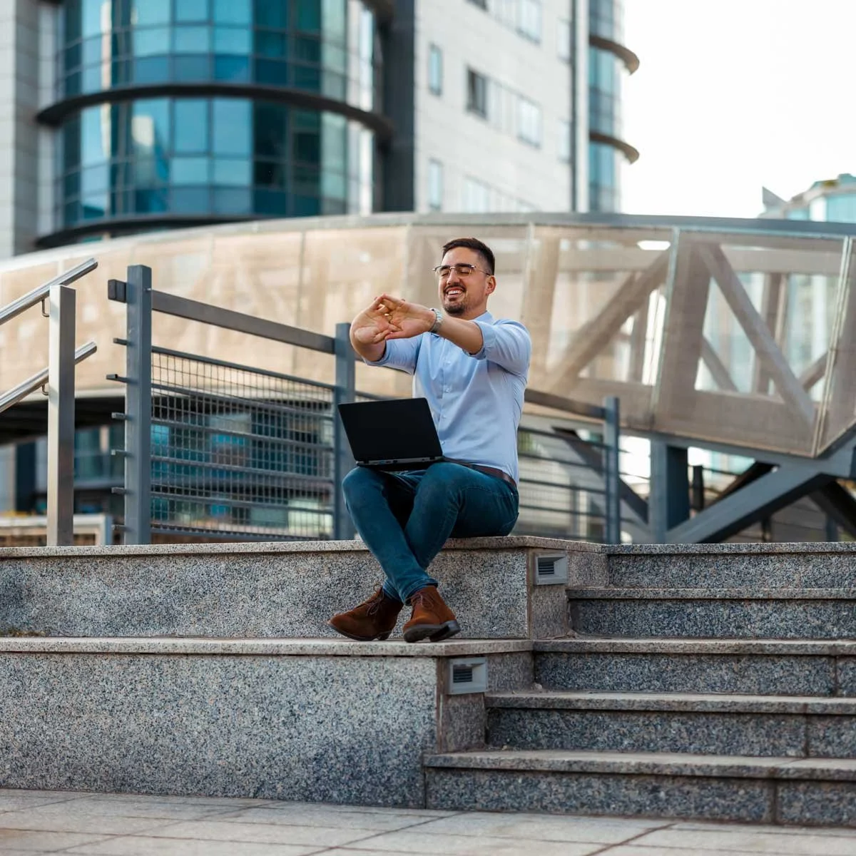Man stretches outside of his office.