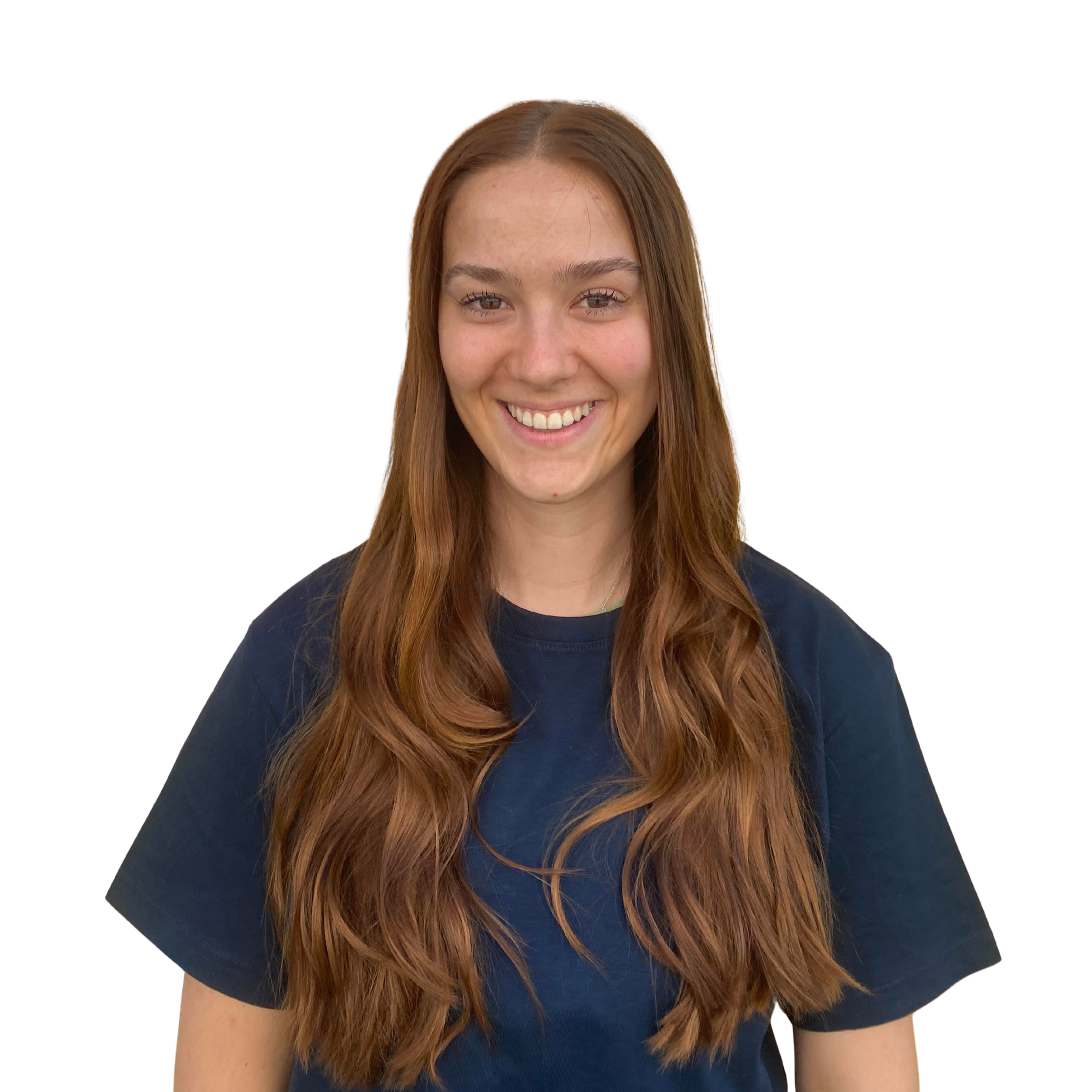 Maggie wears glasses, long brown hair, wearing a navy blue shirt with a logo that says Food Filled.