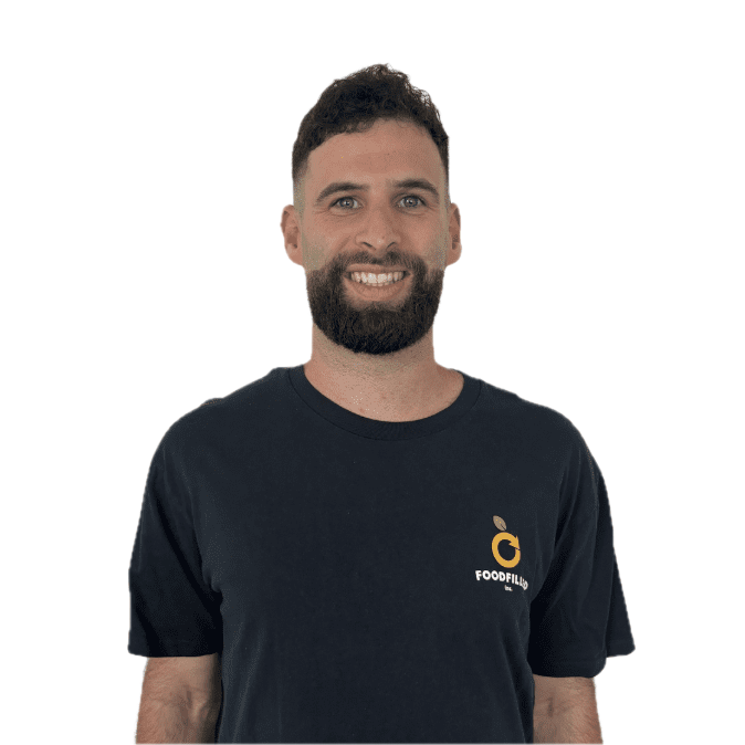 A smiling man with a beard and short dark hair, wearing a black t-shirt with a logo that says 'Foodfilix' on it.