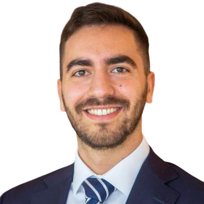 Smiling man with dark hair and beard wearing a dark gray t-shirt with a small yellow logo and the words 'FOODFILLED Inc.'