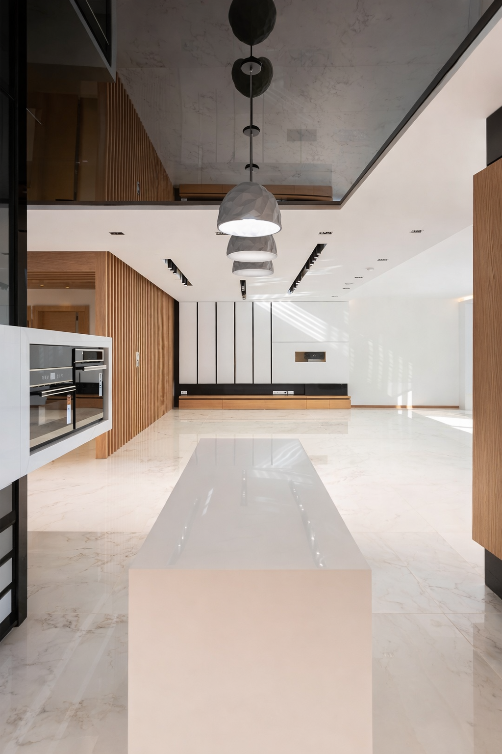 Modern luxury residential kitchen featuring an elongated island, marble flooring, custom cabinetry, and integrated lighting designed by ReArt.
