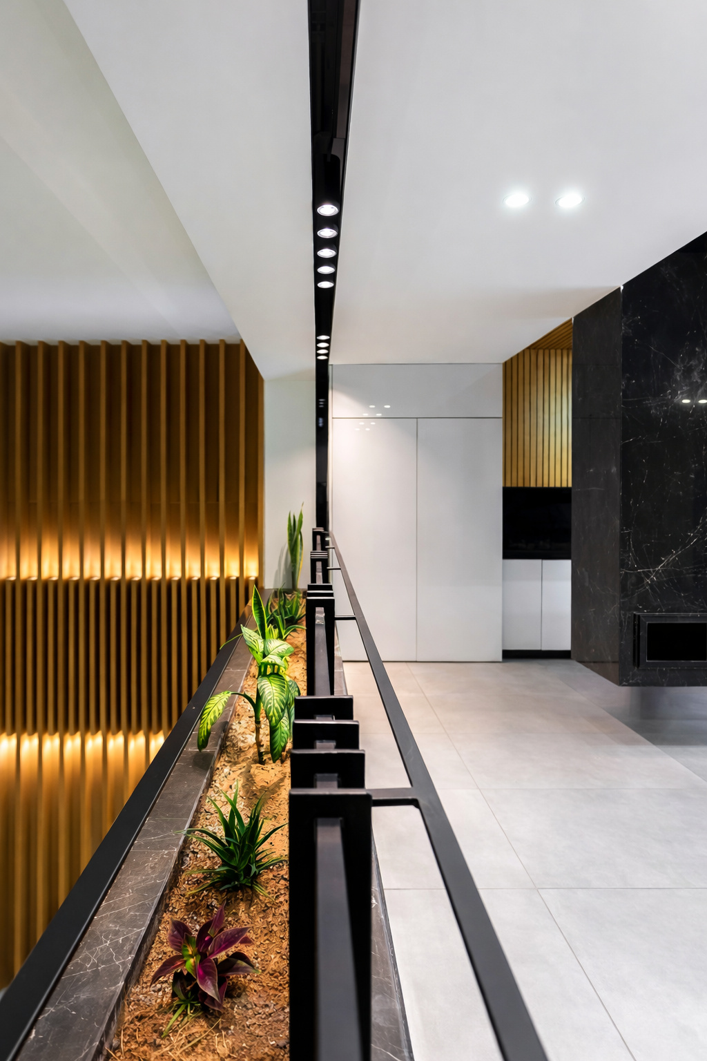 Luxury residential interior gallery featuring integrated planters, architectural lighting, stone flooring, and custom metal railing designed by ReArt.