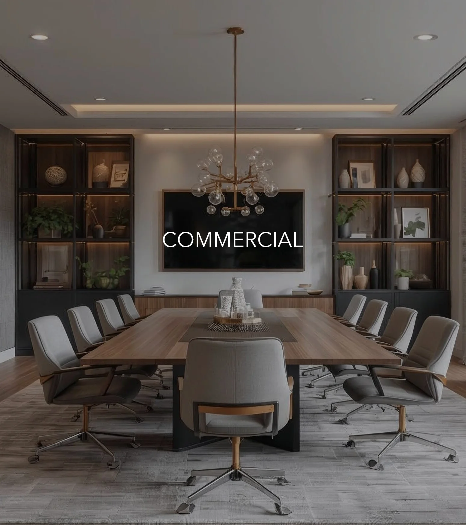 Modern commercial boardroom featuring custom wood millwork, integrated shelving, a large conference table, sculptural chandelier, and a refined, professional atmosphere.