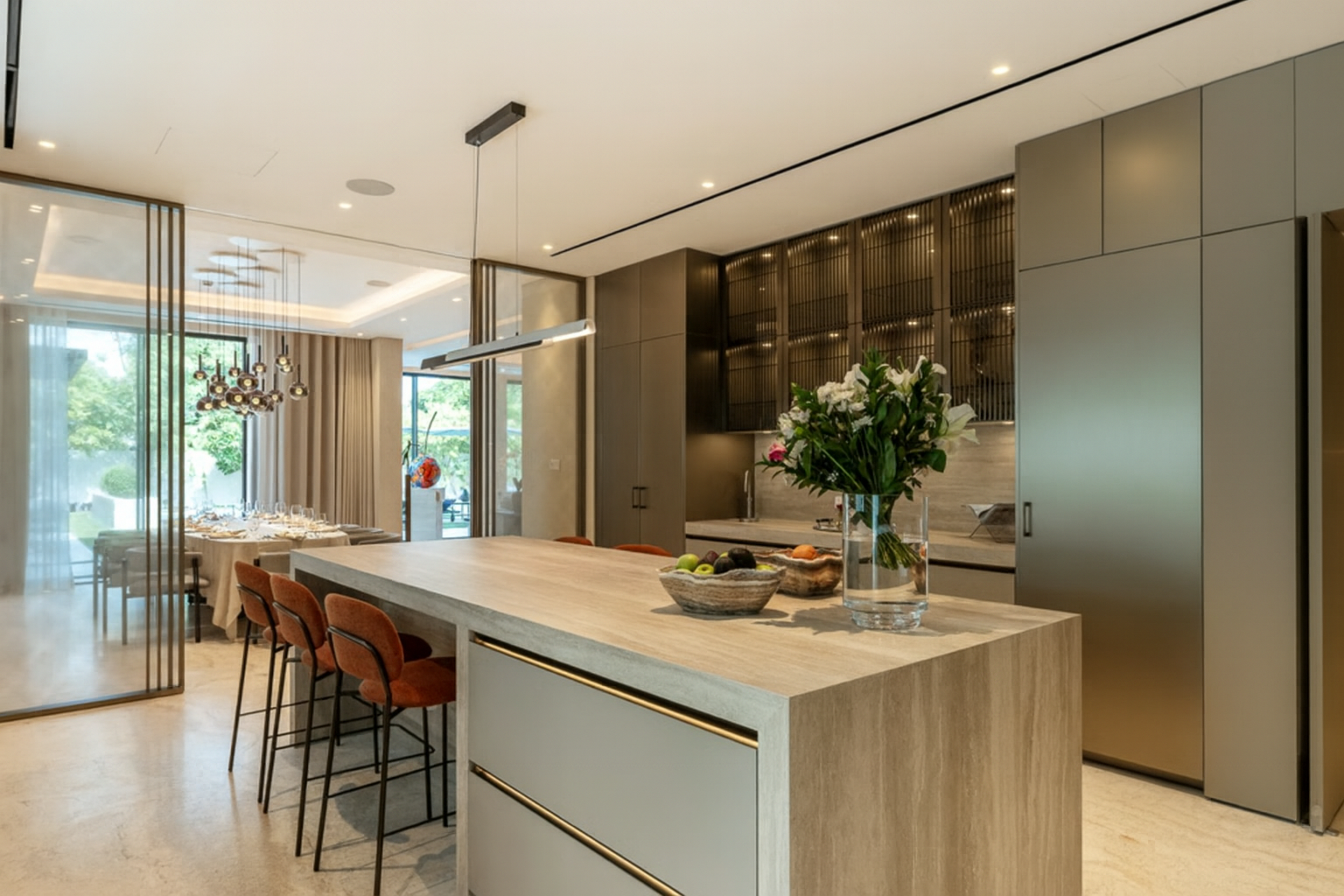 Luxury open-plan residential kitchen featuring a stone island, integrated cabinetry, and seamless connection to dining spaces by ReArt.
