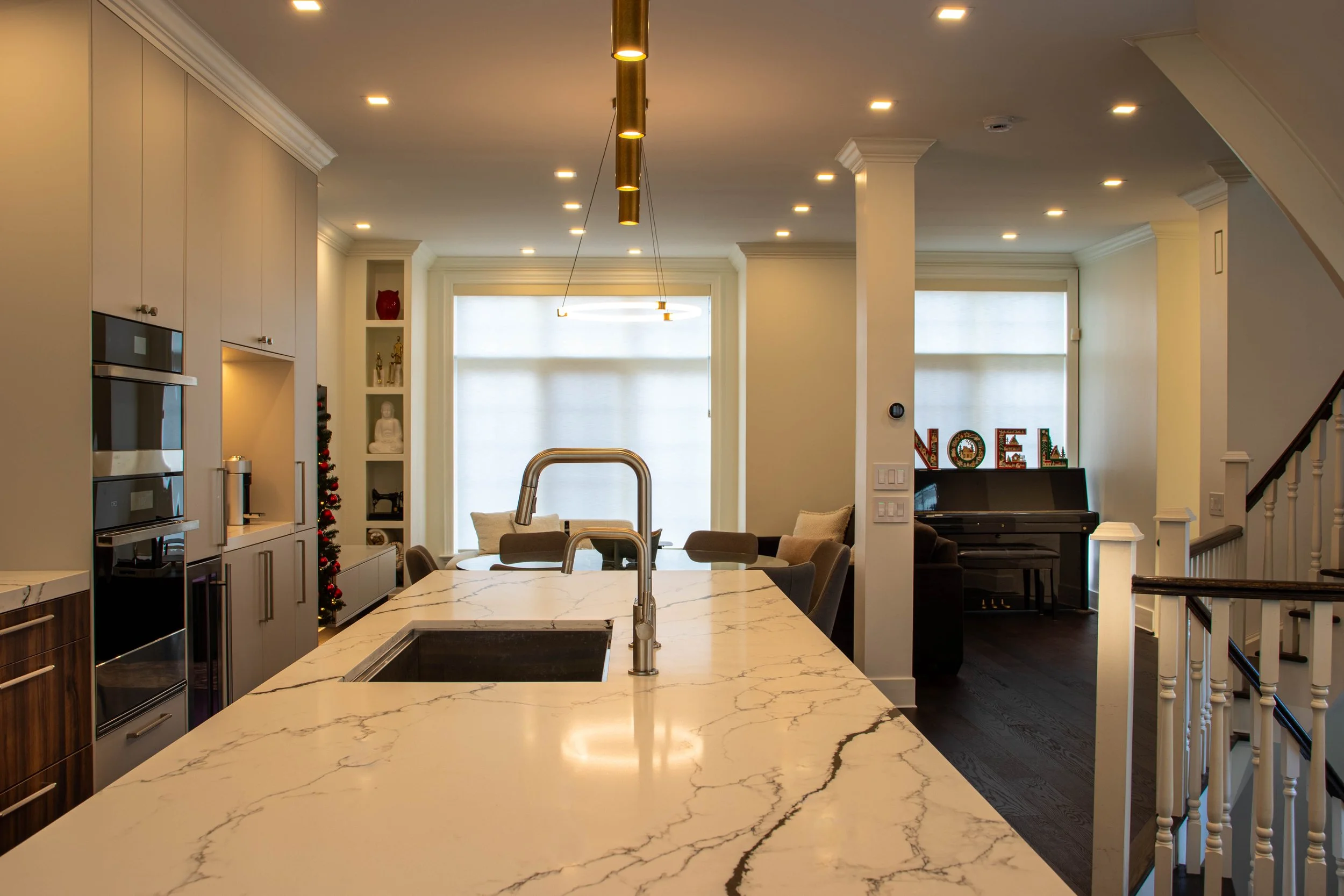 Luxury open-concept kitchen and dining space with custom cabinetry and modern lighting in Toronto