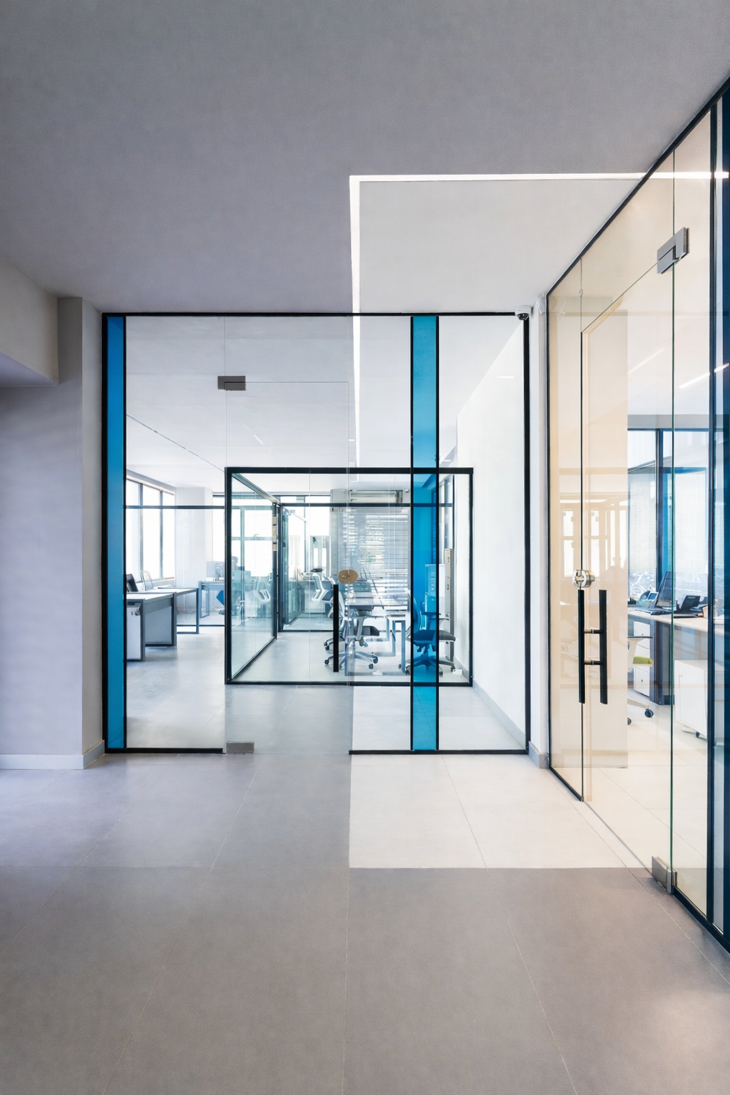 Contemporary office design featuring glass walls, neutral tones, and a streamlined open-plan commercial interior.