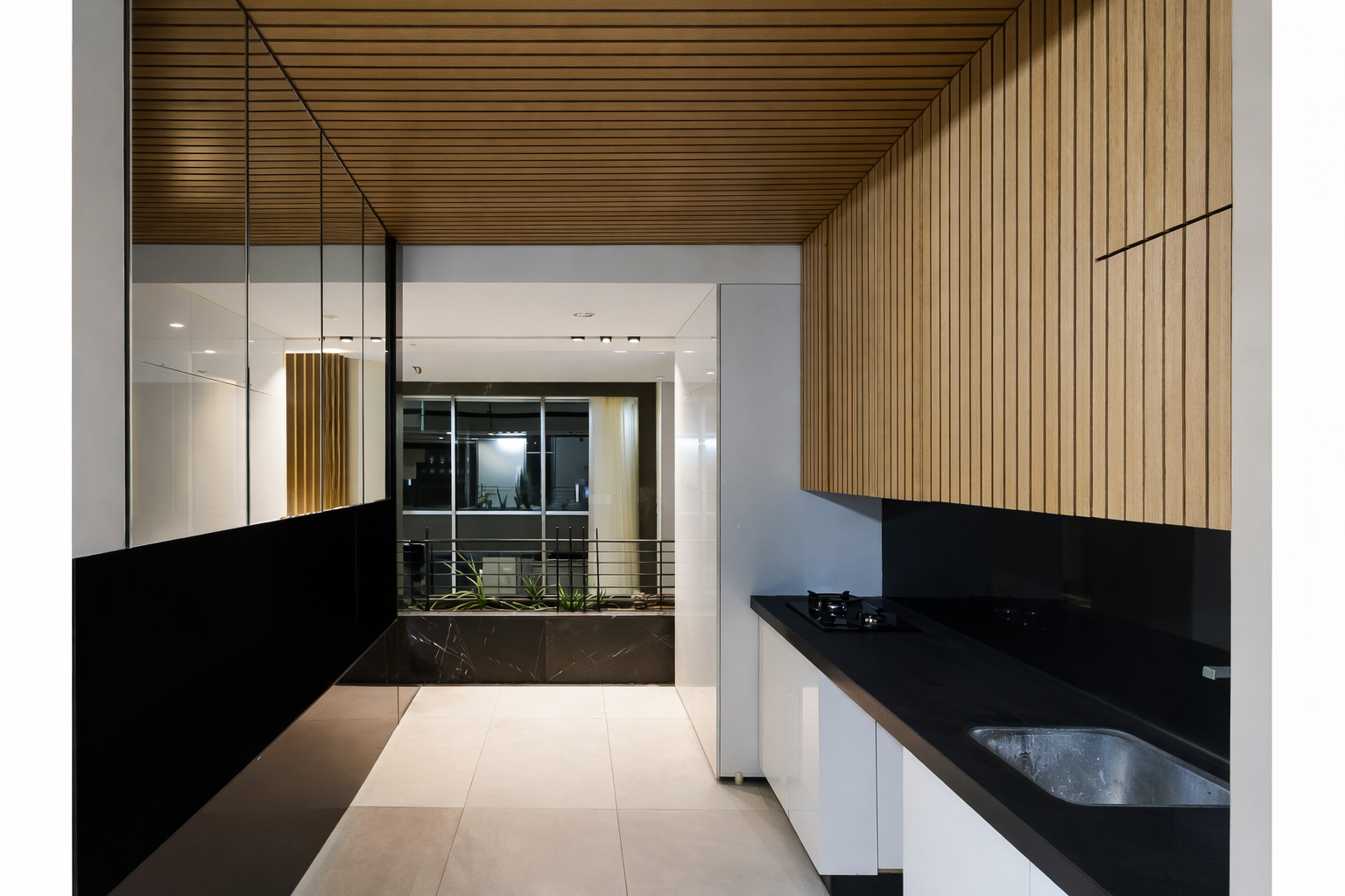 Luxury residential kitchen detail highlighting wood slat ceiling treatment, black countertops, and refined modern finishes by ReArt.