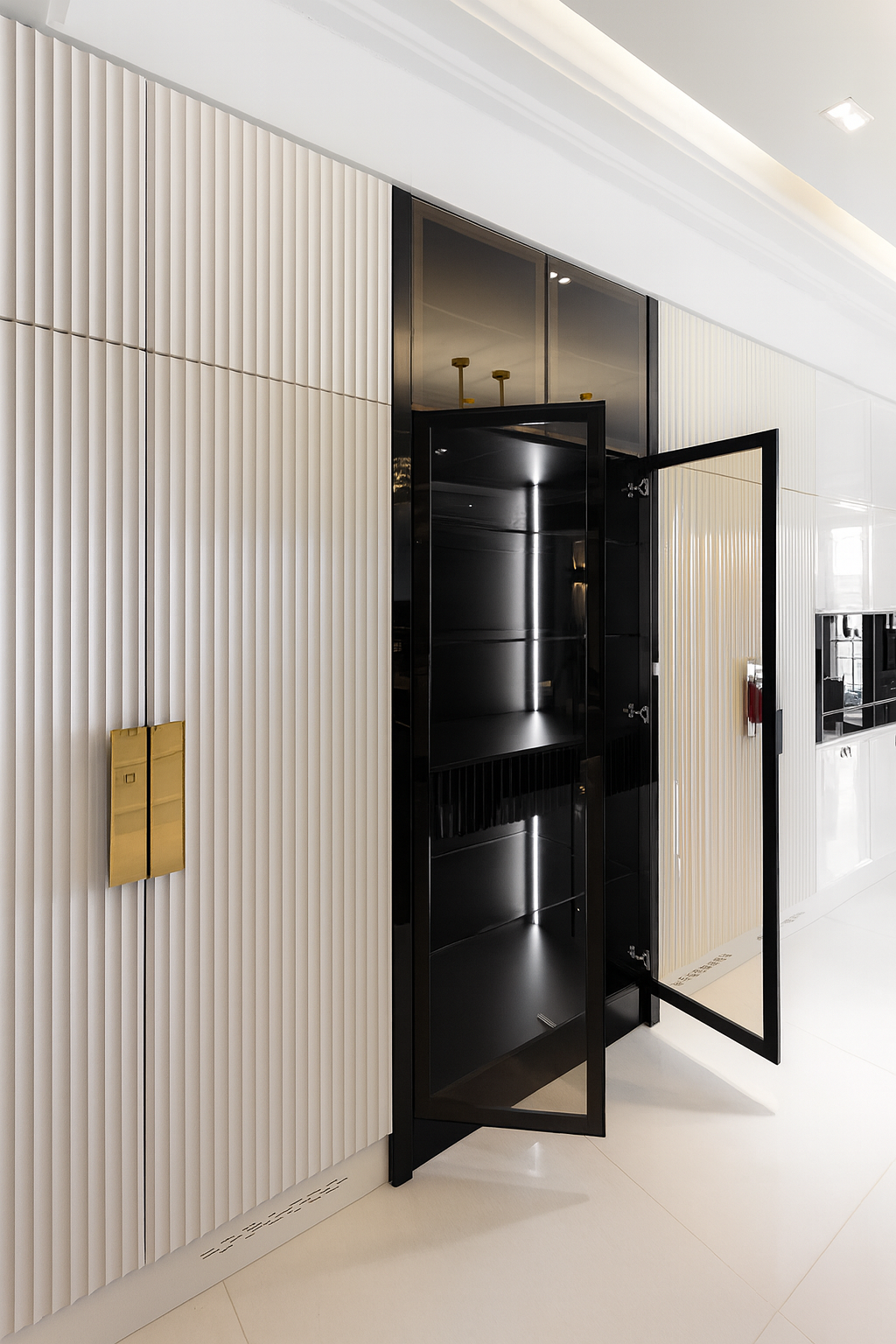 Hidden pantry design with fluted wall panels, concealed glass door, and custom cabinetry for a seamless modern kitchen aesthetic.