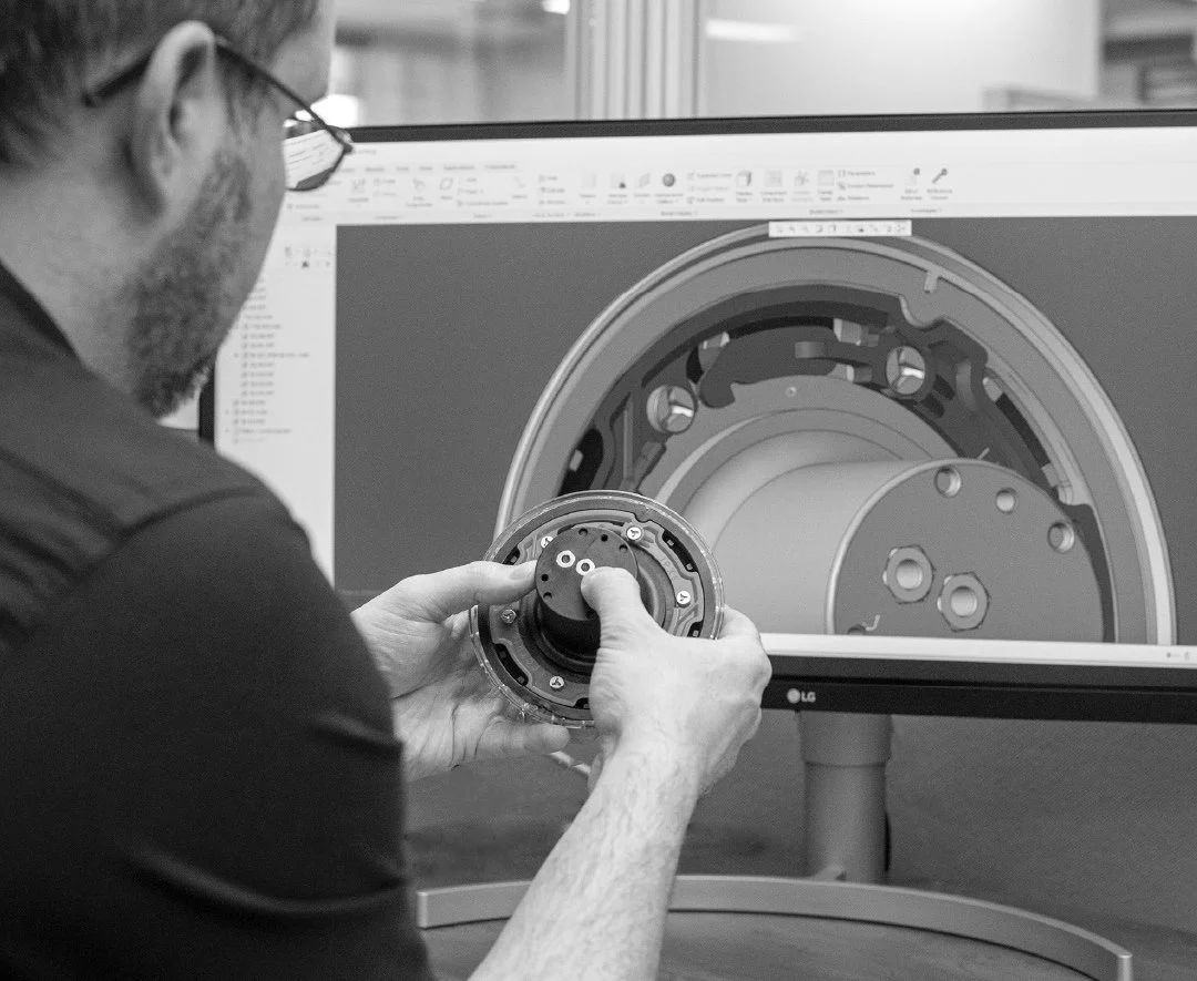 A Spa Electrics employee inspecting a Retro Fit replacement pool light fitting.