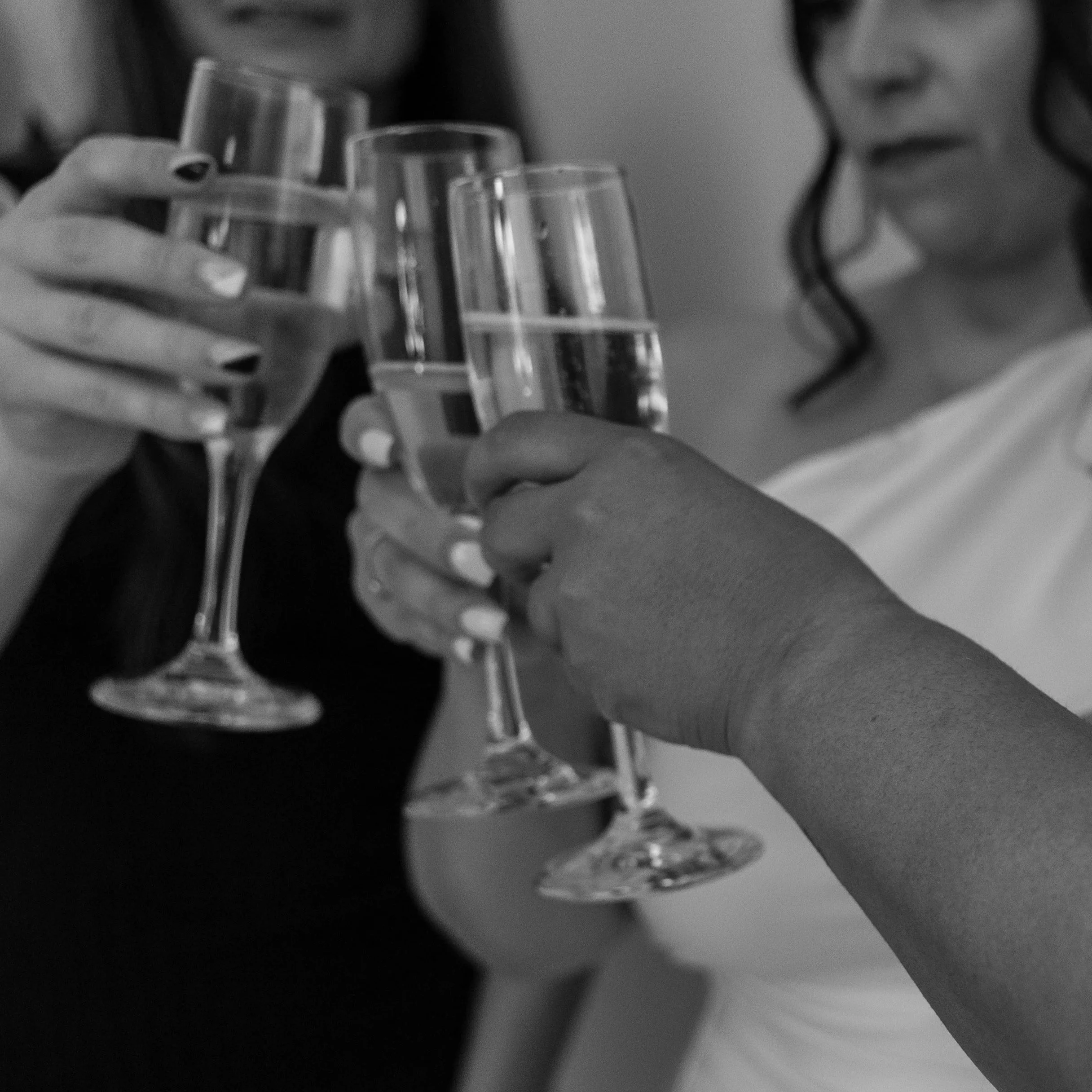 People clinking glasses of champagne in a celebration.