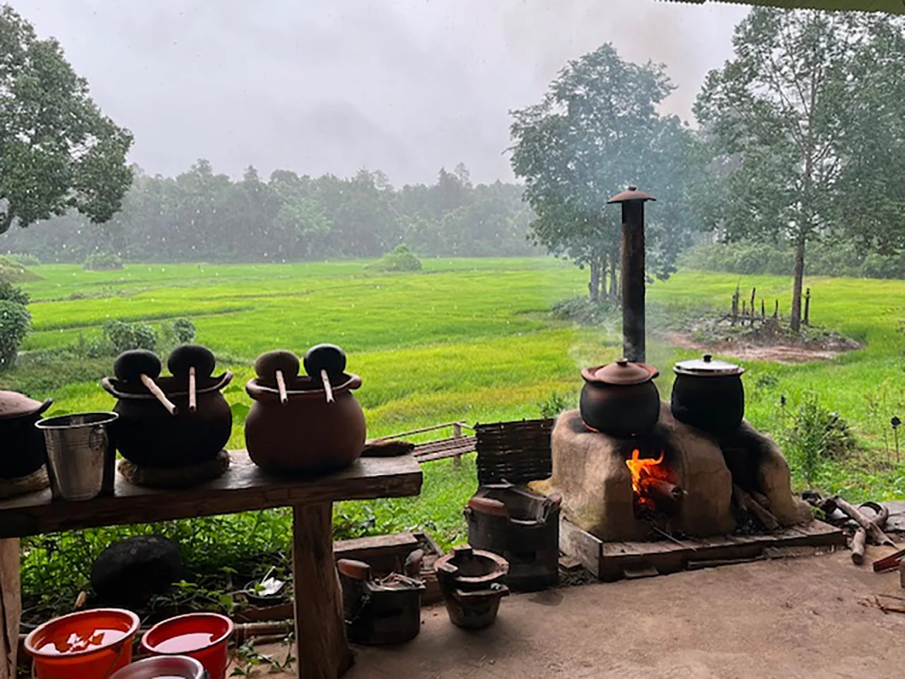 Cookfire with rice field in the background