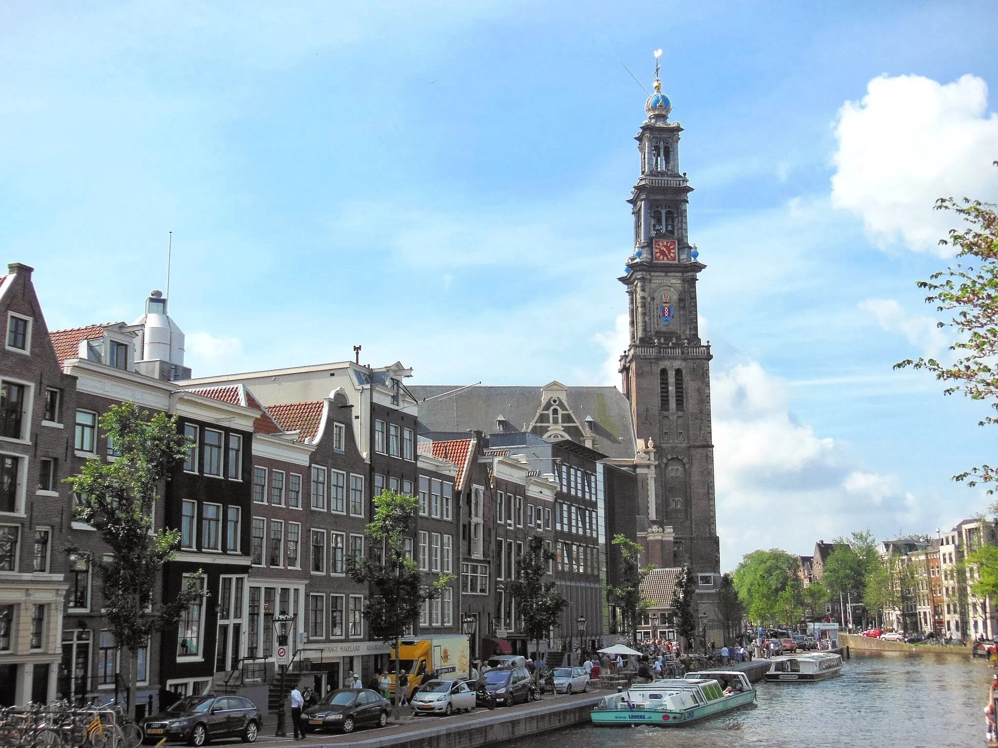 Laurie’s customers, Mariana and Carmen holding hands on a green lawn on their wedding day.