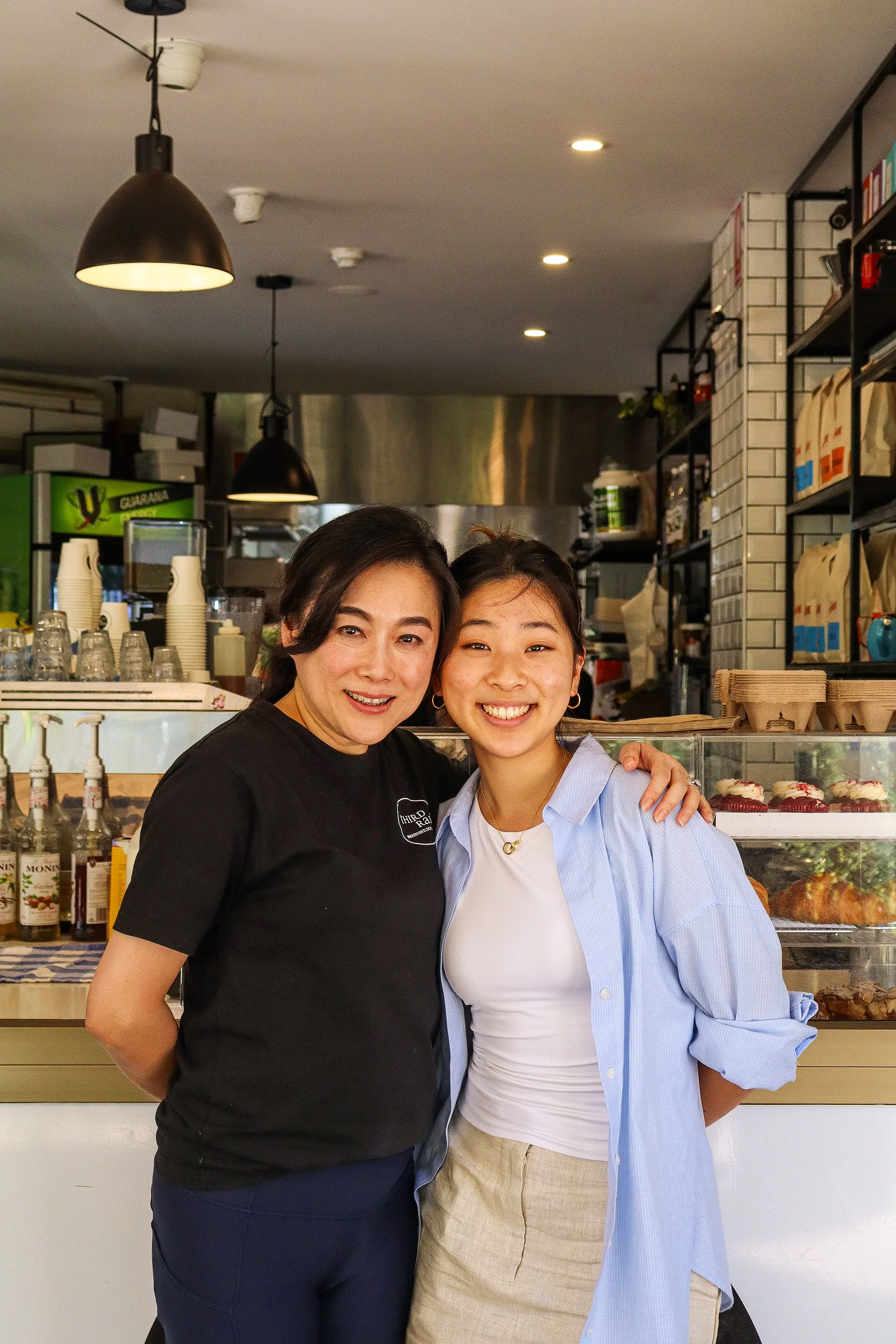 Third Rail Cafe Waverton owner Angelica Liang and daugther smiling