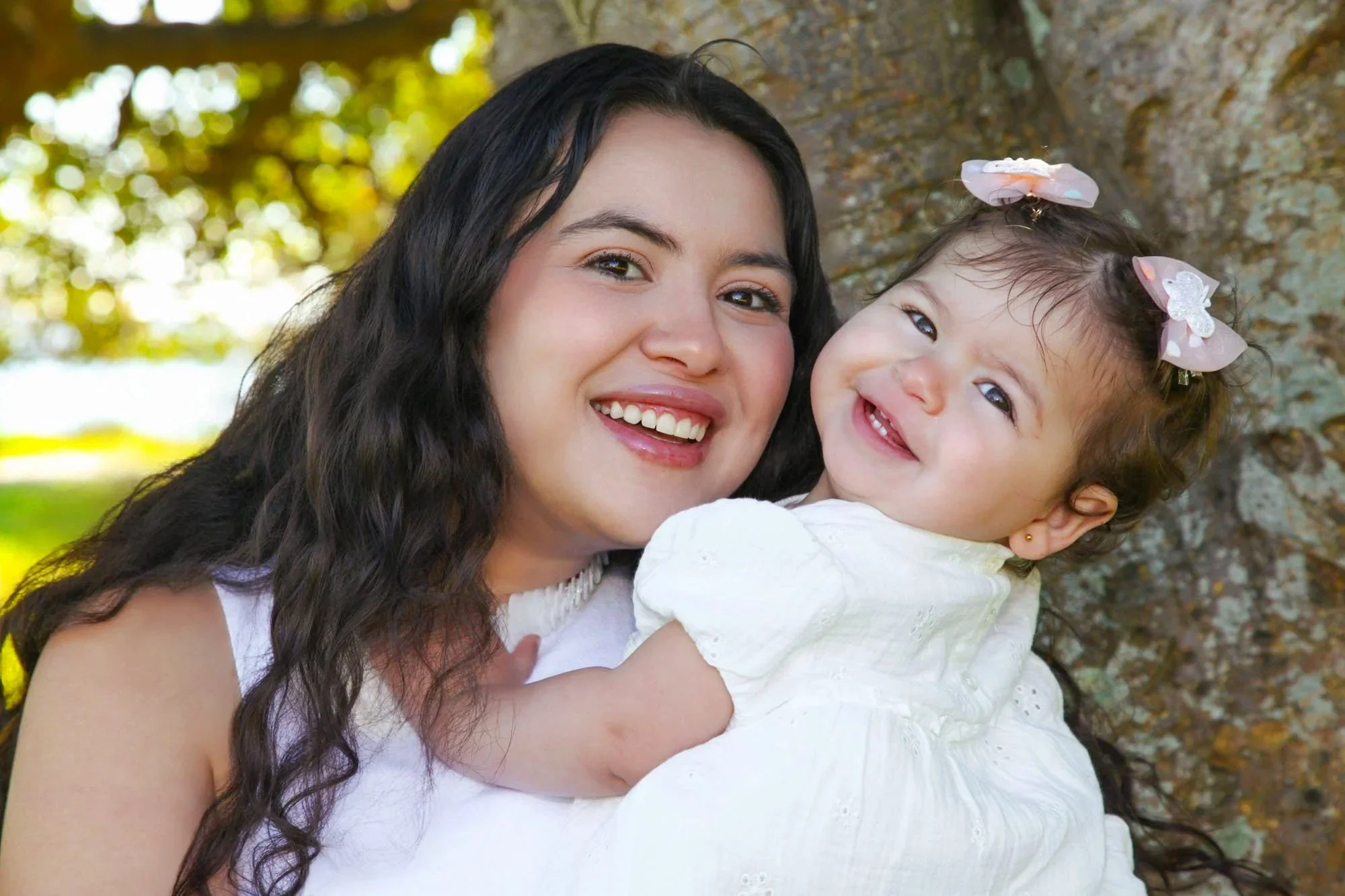 A mother holding her baby during a natural outdoor family photoshoot captured by Southern Exposure Photography.