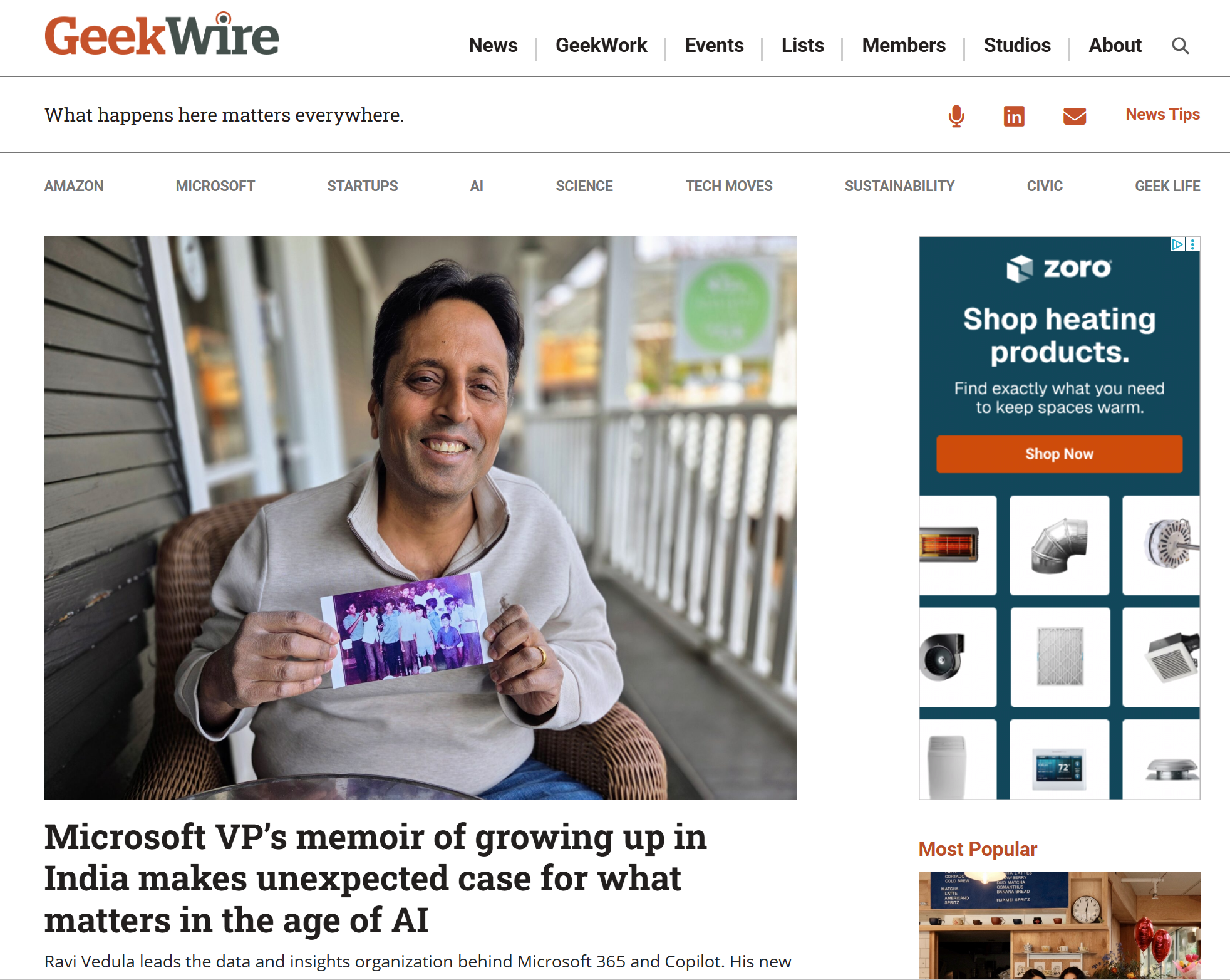 Ravi Vedula sits outdoors holding a childhood photograph, featured in a GeekWire article about his memoir on growing up in India.