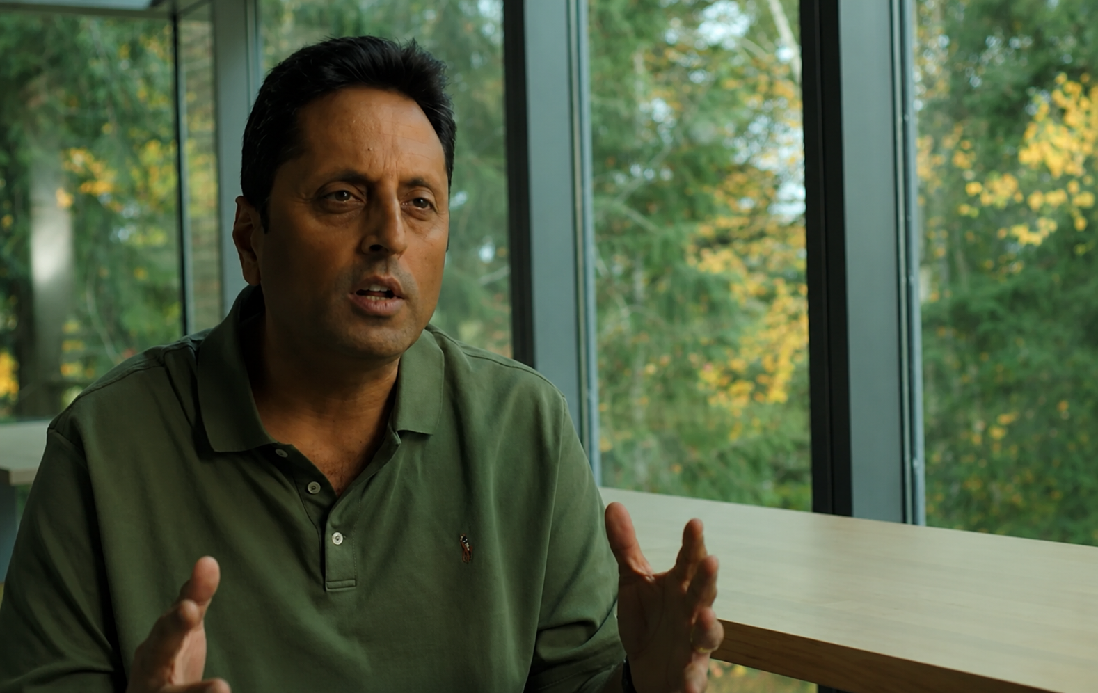 Image of a man in a green polo shirt 