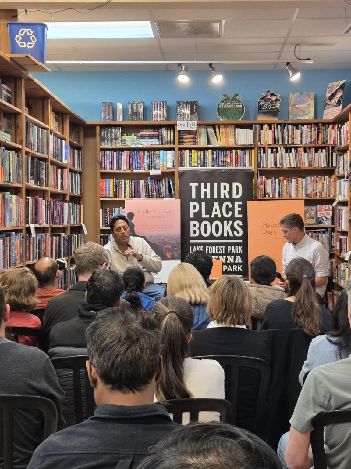 Ravi Vedula speaking with moderator Chris Harig during a Hyderabad Days book talk at Third Place Books.