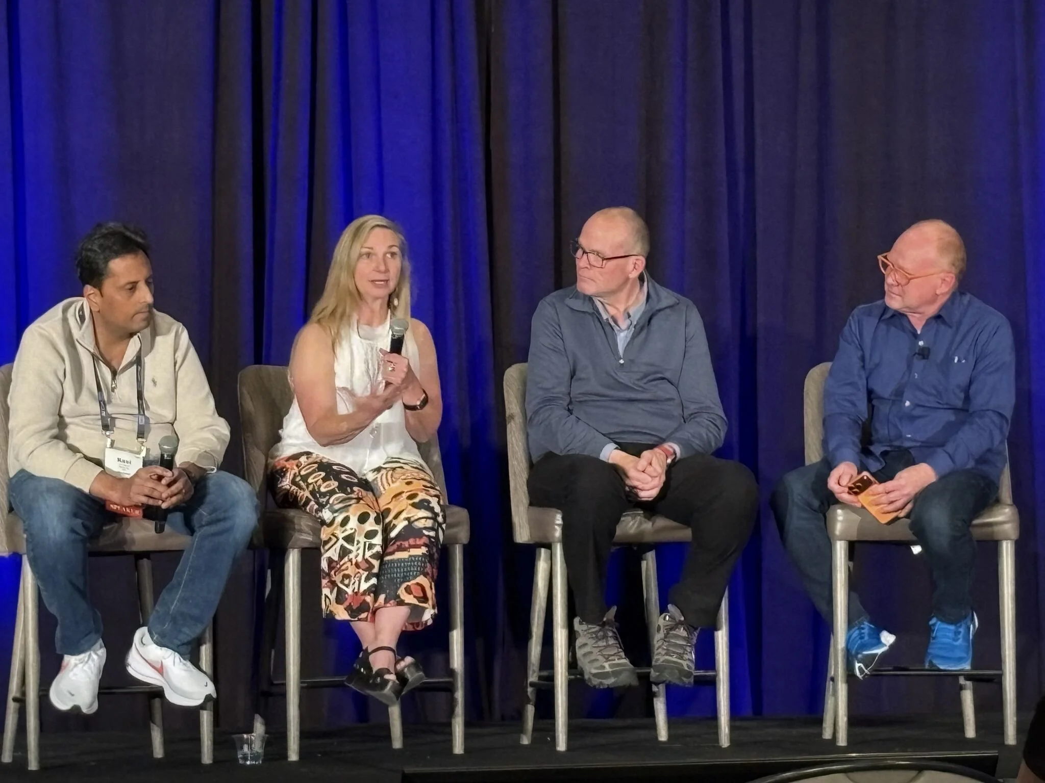 Four panelists at AI con in a discussion