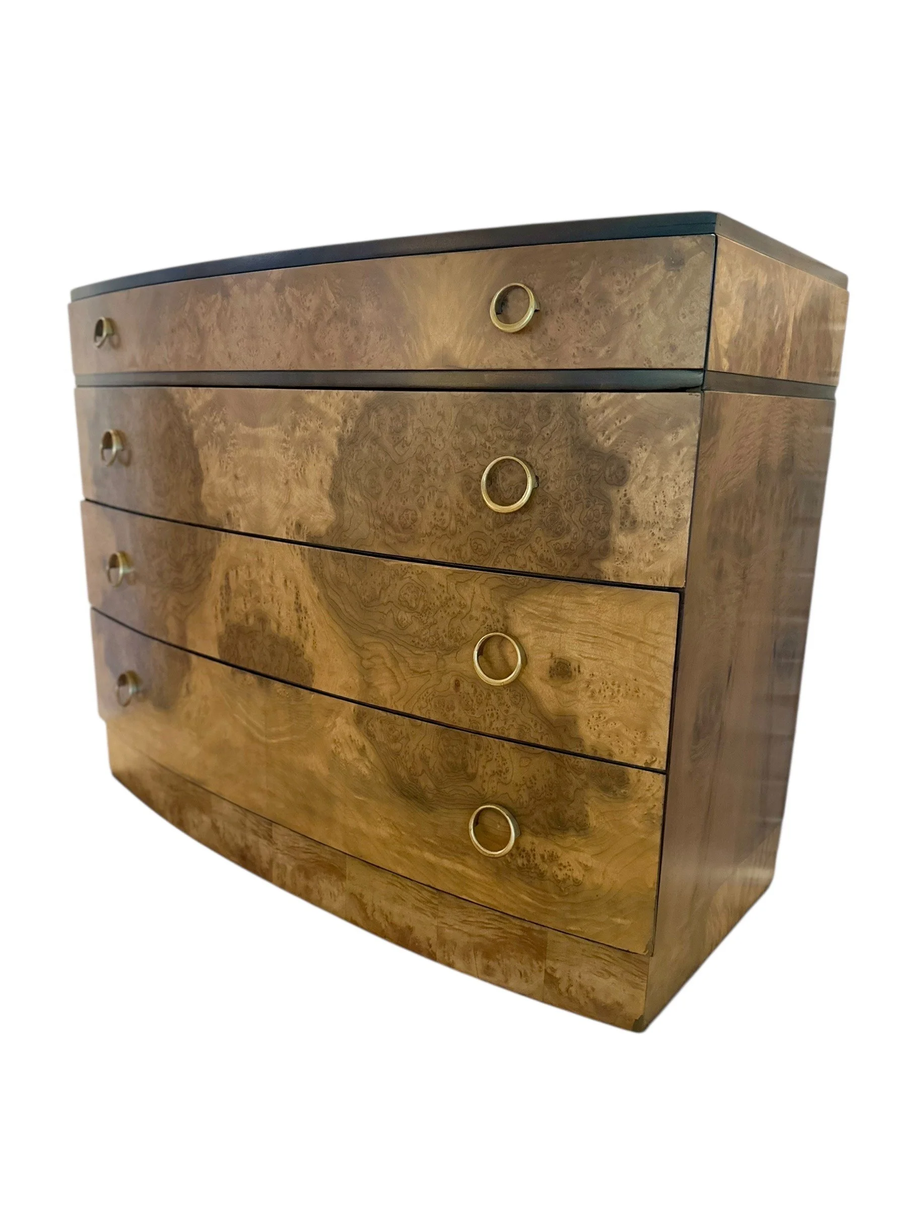 A wooden dresser with four drawers, each with a circular gold handle, and a slightly curved front, set against a plain background.