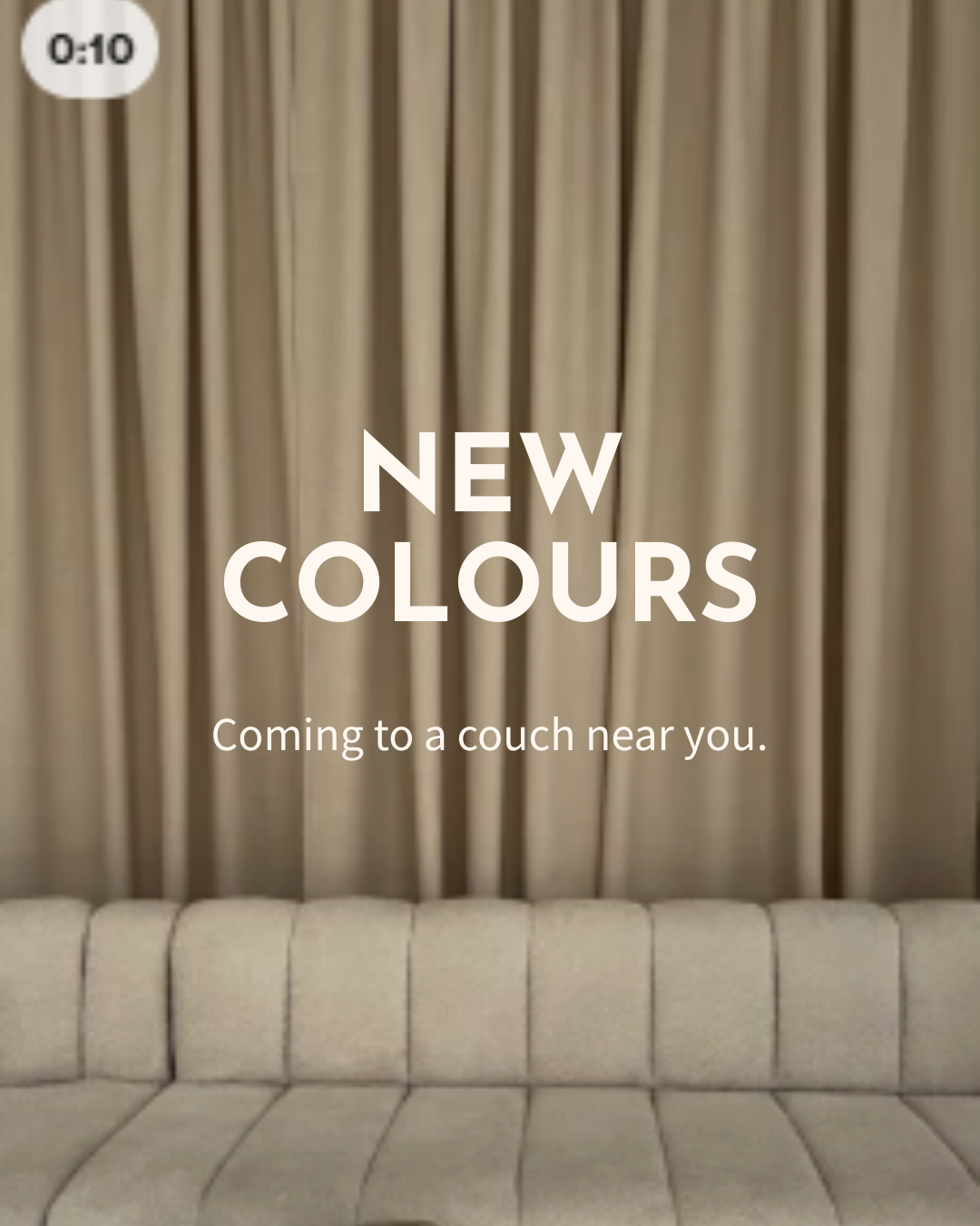 Announcement of new colors arriving for sofas, with a beige sofa in front and beige curtains in the background.