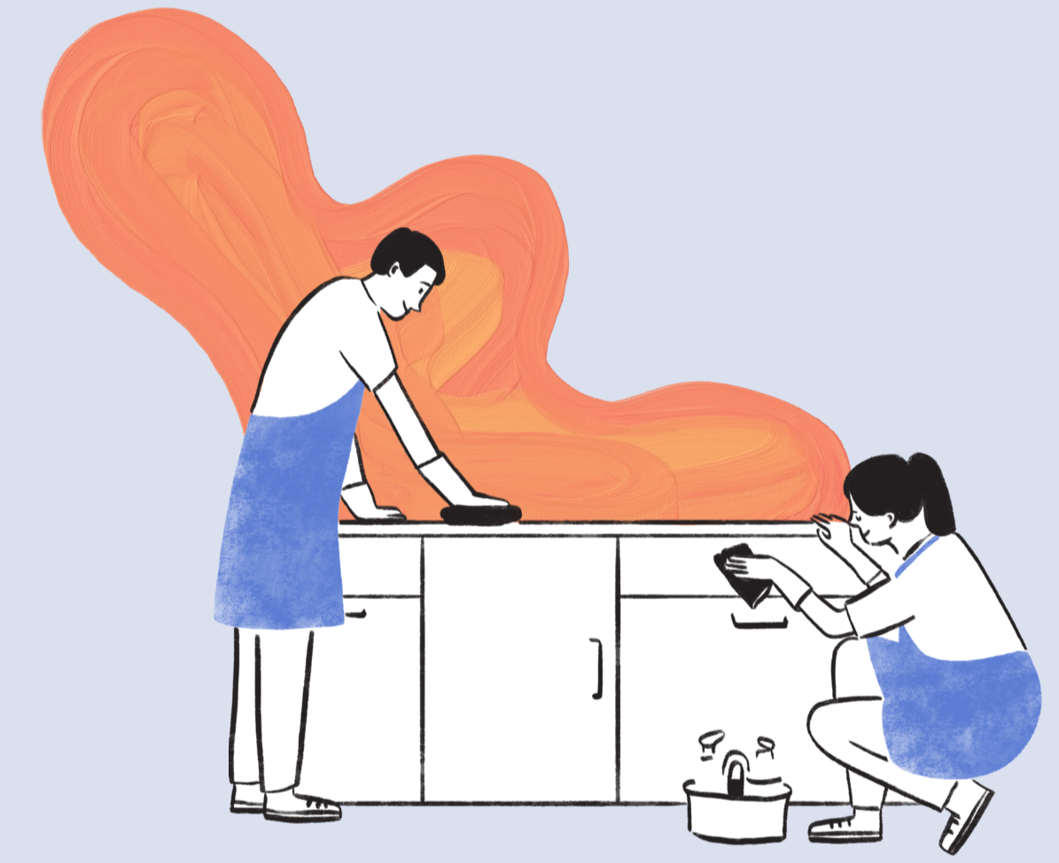 Two women are cleaning a kitchen countertop with a large orange flame in the background.