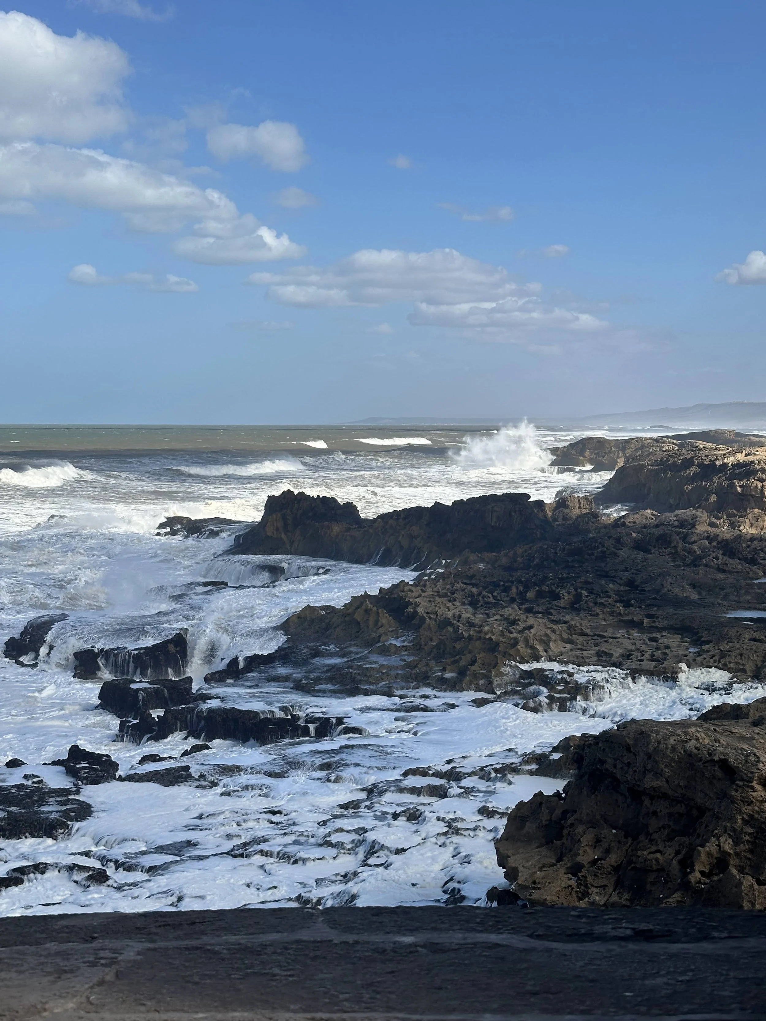 Atlantic waves breaking against a rocky shoreline in Essaouira, Morocco