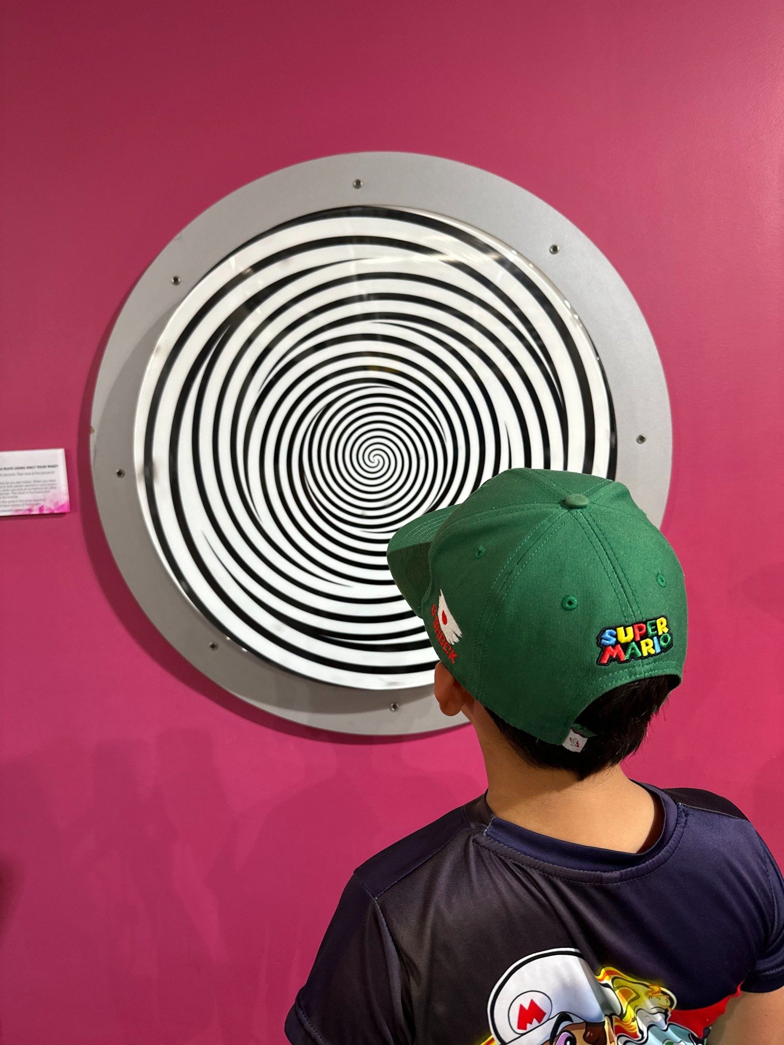 Child looking at black and white spiral optical illusion representing stepping back from burnout patterns in therapy with Rosalie Maduro LMFT in Los Angeles, San Francisco, and Park City