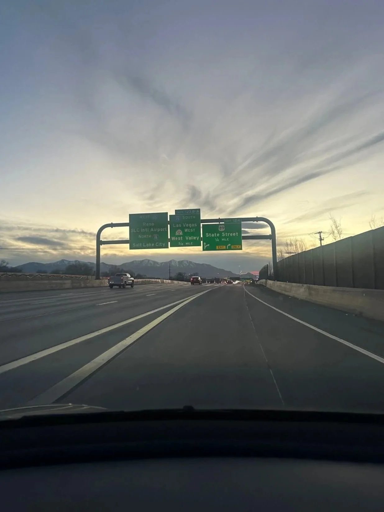 Highway through the mountains in Utah with directional road signs