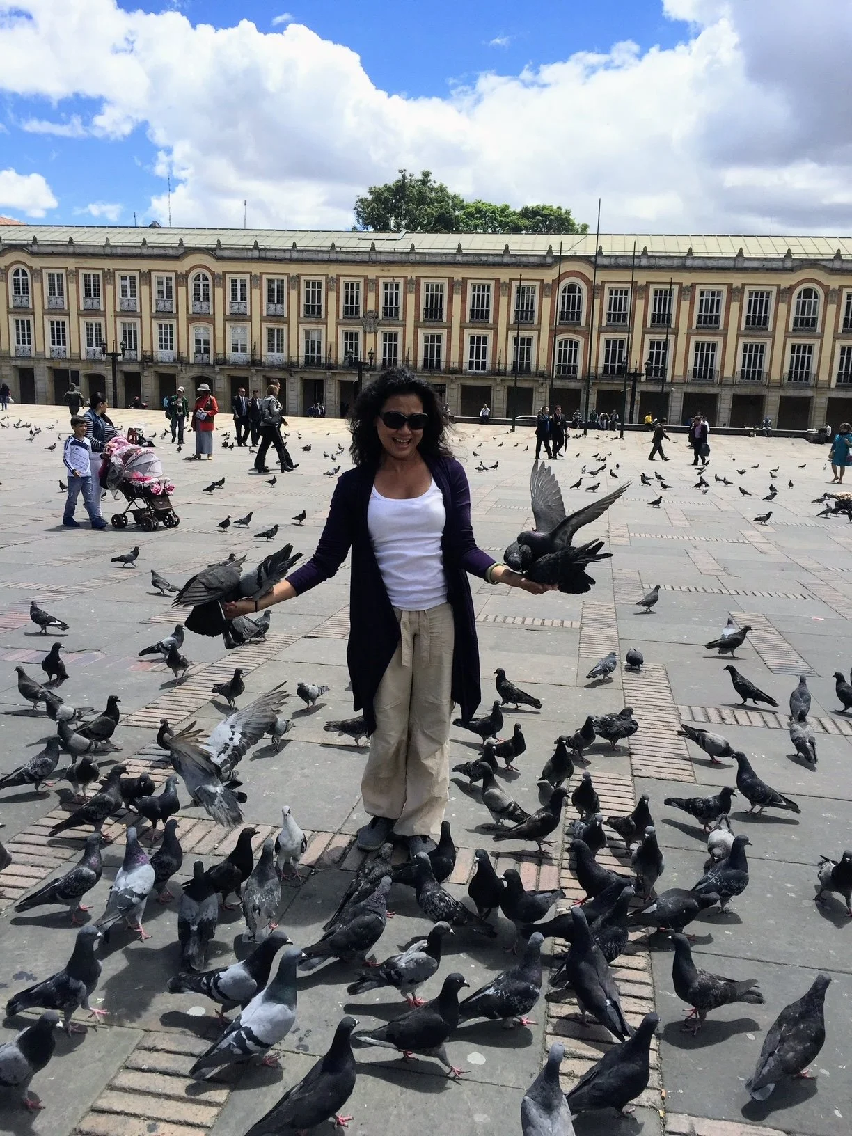 Rosalie Maduro standing among pigeons in a public square in Colombia