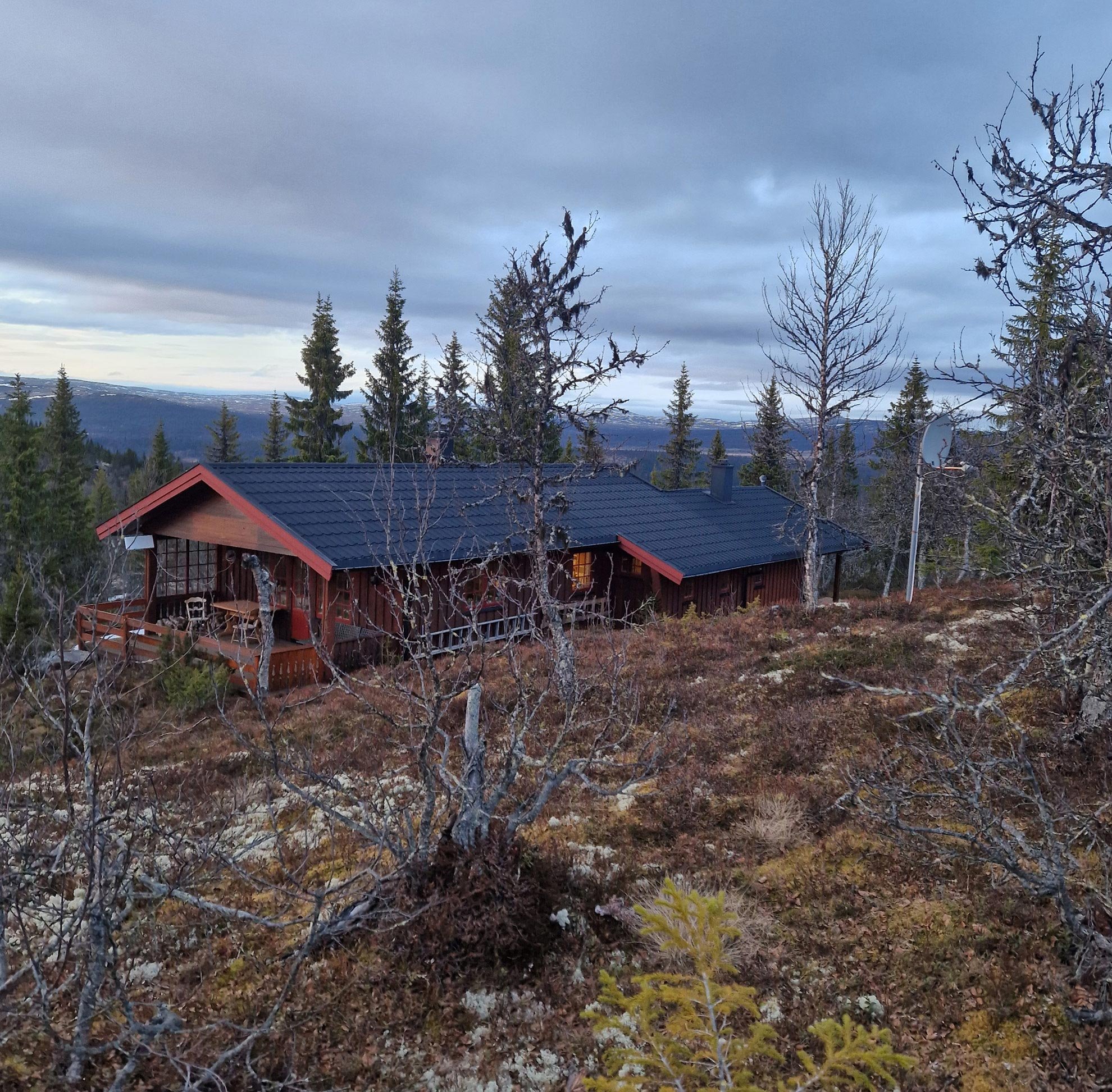 Our cabin in the forest, norwegian style cabin. With a cloudy sky in the background.