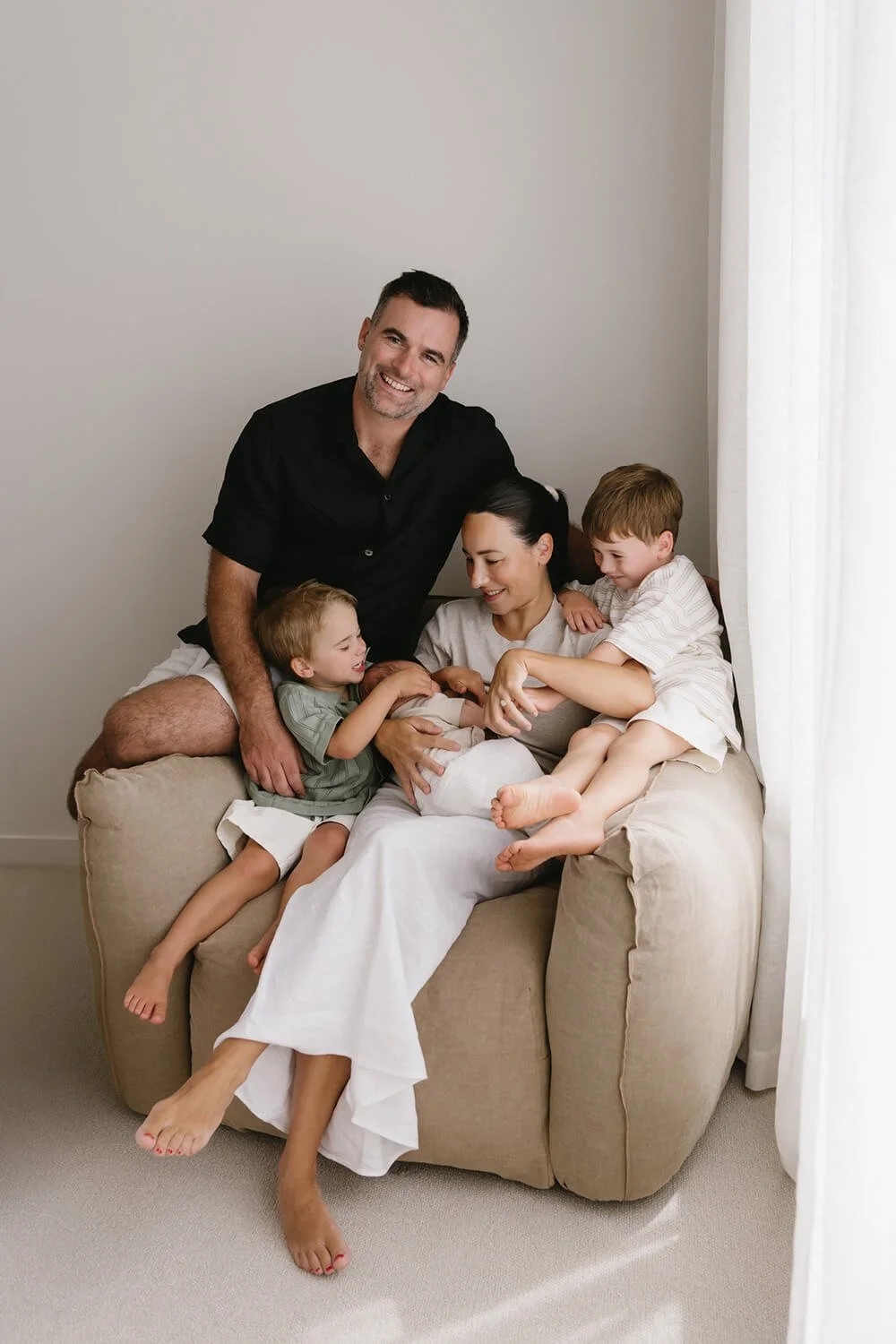 New baby and family having their photo taken by Hobart family photographer