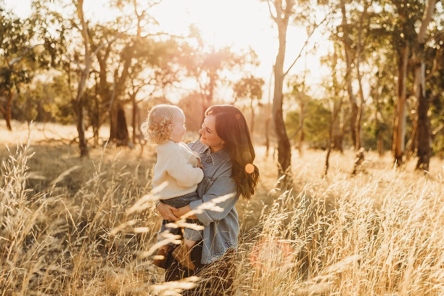 Photo of Meegan Wilmot from Meegan Wilmot Photographer and her daughter in a golden field
