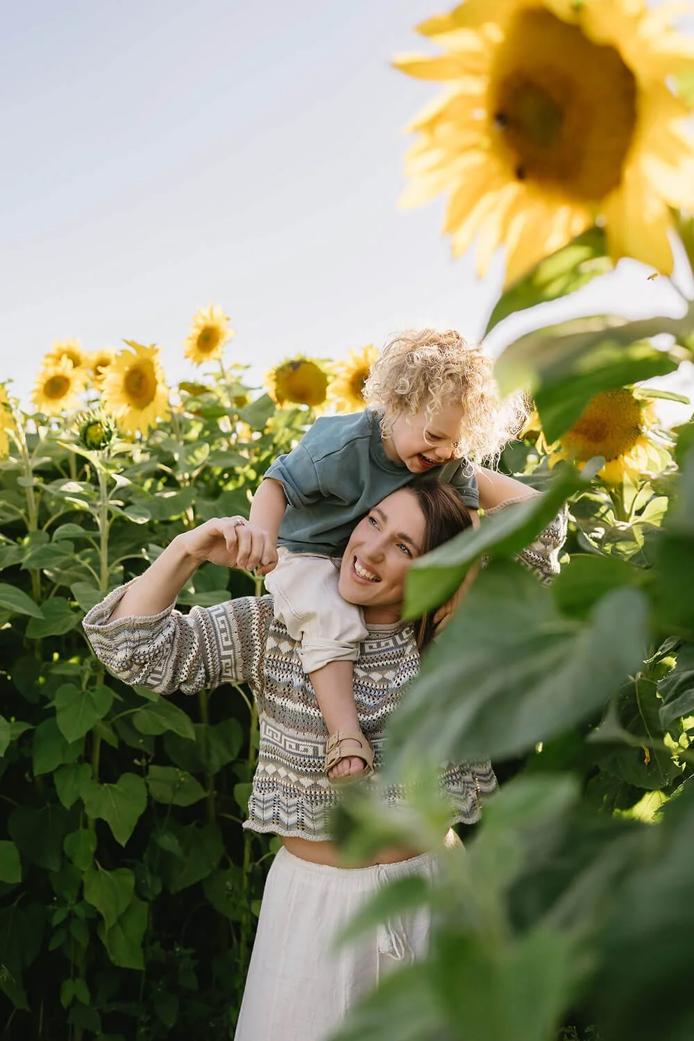 Mum and son in sunflower field having their photo taken by Hobart Photographer