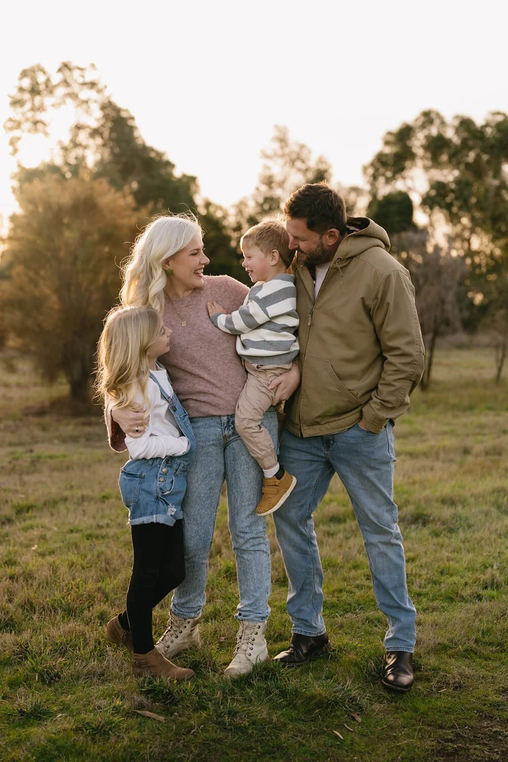 Family in field having their photo taken by Hobart family photographer