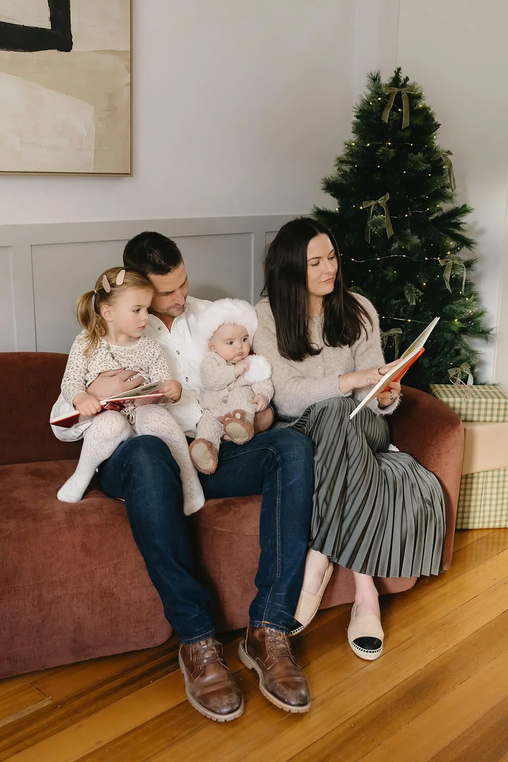Family Christmas photo beside the Christmas tree at White Cottage South in Hobart