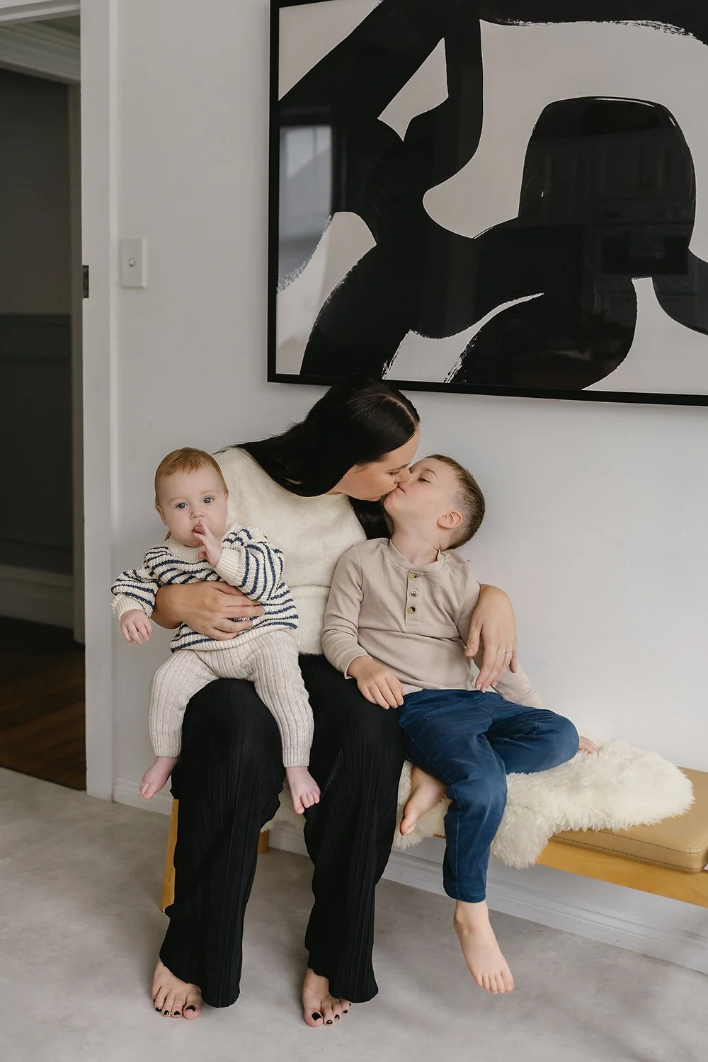 Mother and children sitting on bench