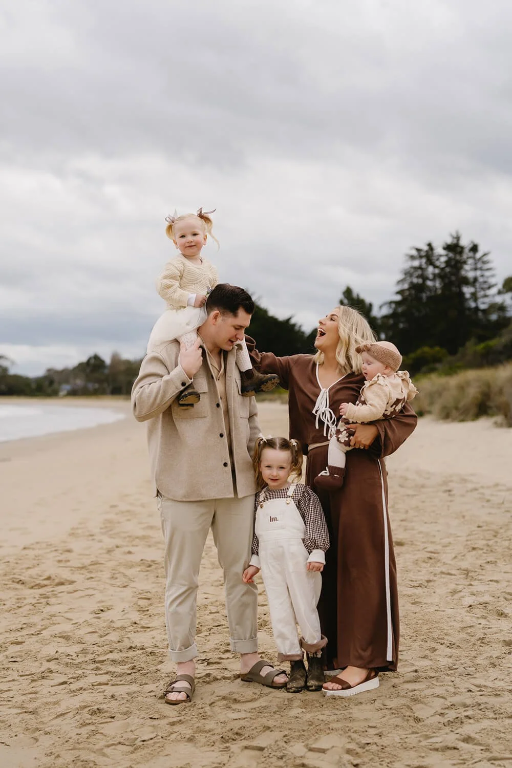 Hobart family on beach being photographed by Hobart family photographer