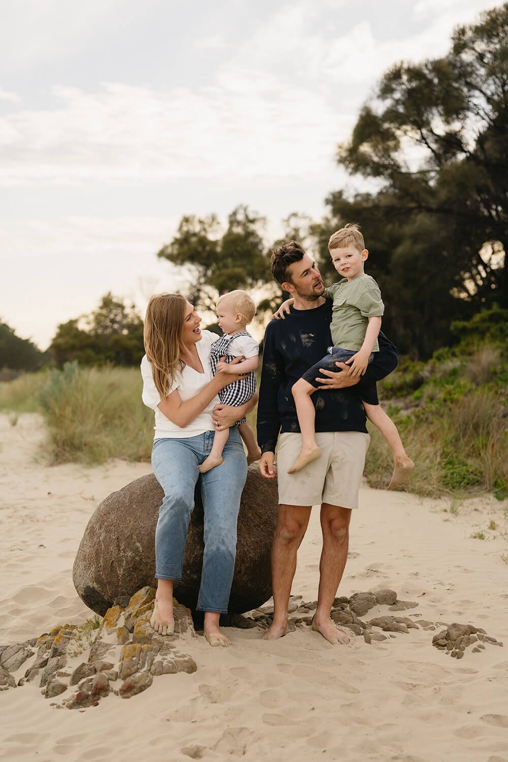 Family sitting on beach steps at Roches Beach family photoshoot
