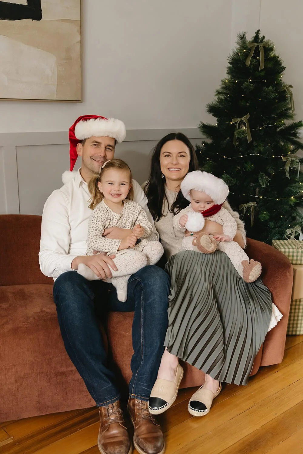 Family enjoying a cosy Christmas mini session at White Cottage South in Sandy Bay, Hobart