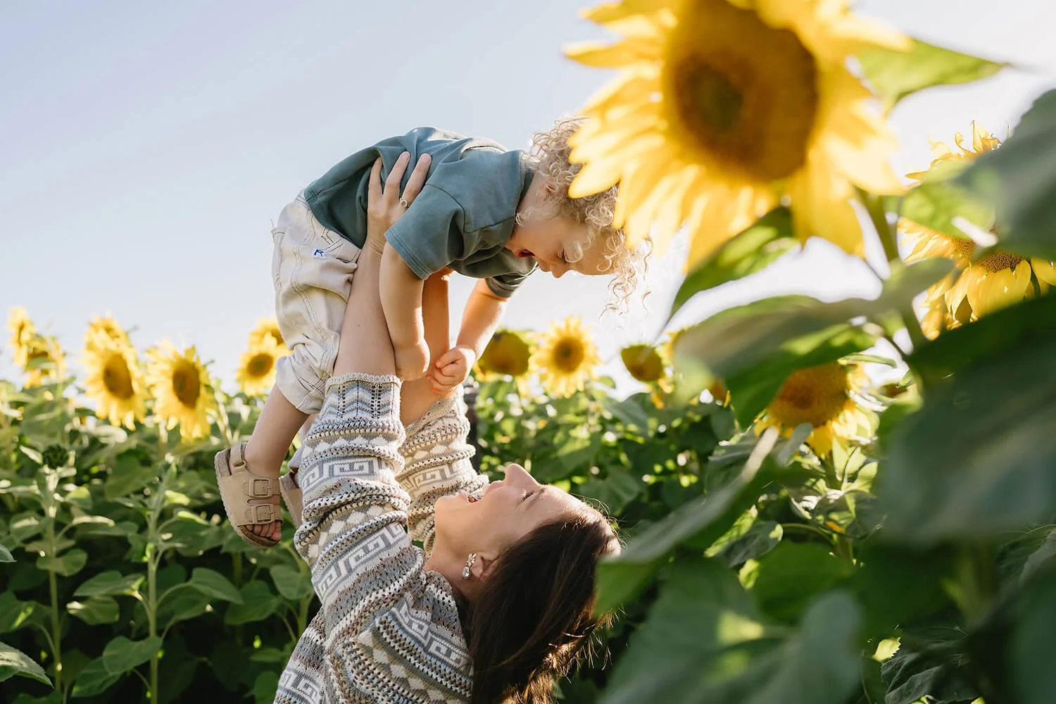 Mother holding her son up in the air playing during a Motherhood Photography session in Hobart.