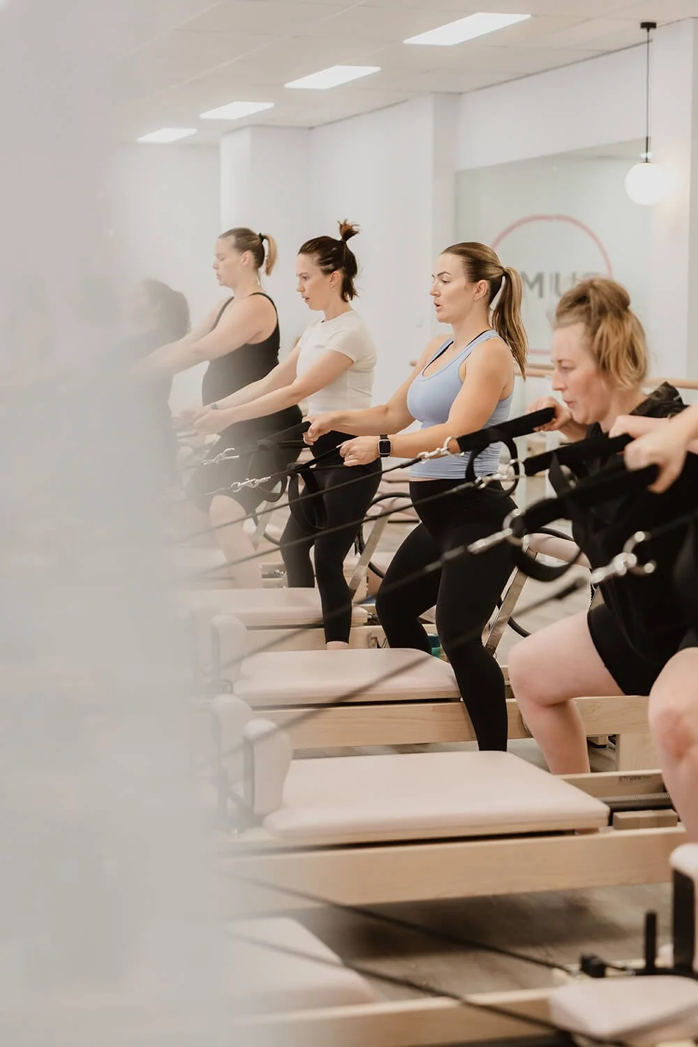 Hobart Pilates class training being photographed by branding photographer in Hobart