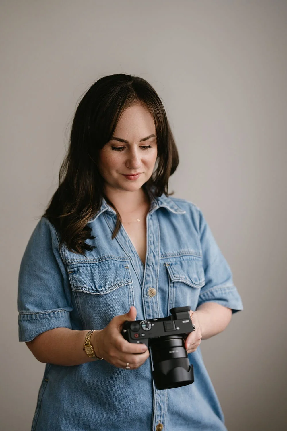 Photo of Hobart photographer Meegan Wilmot looking at her camera
