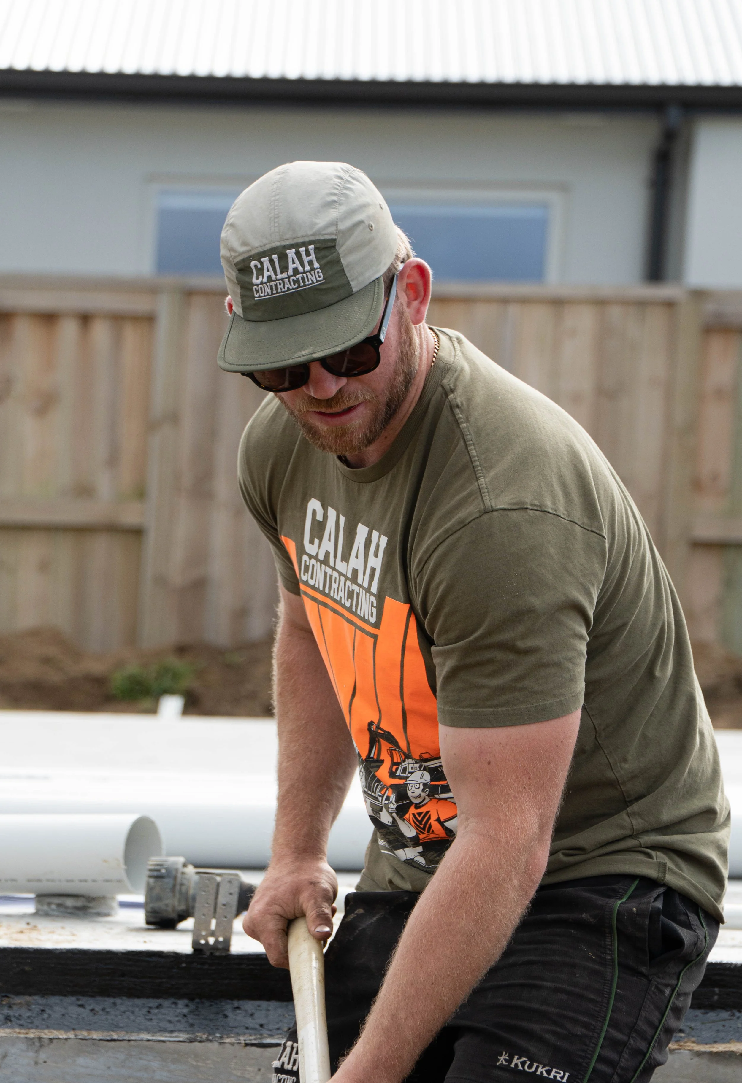 Calah Contracting workers using hand tools on a construction site