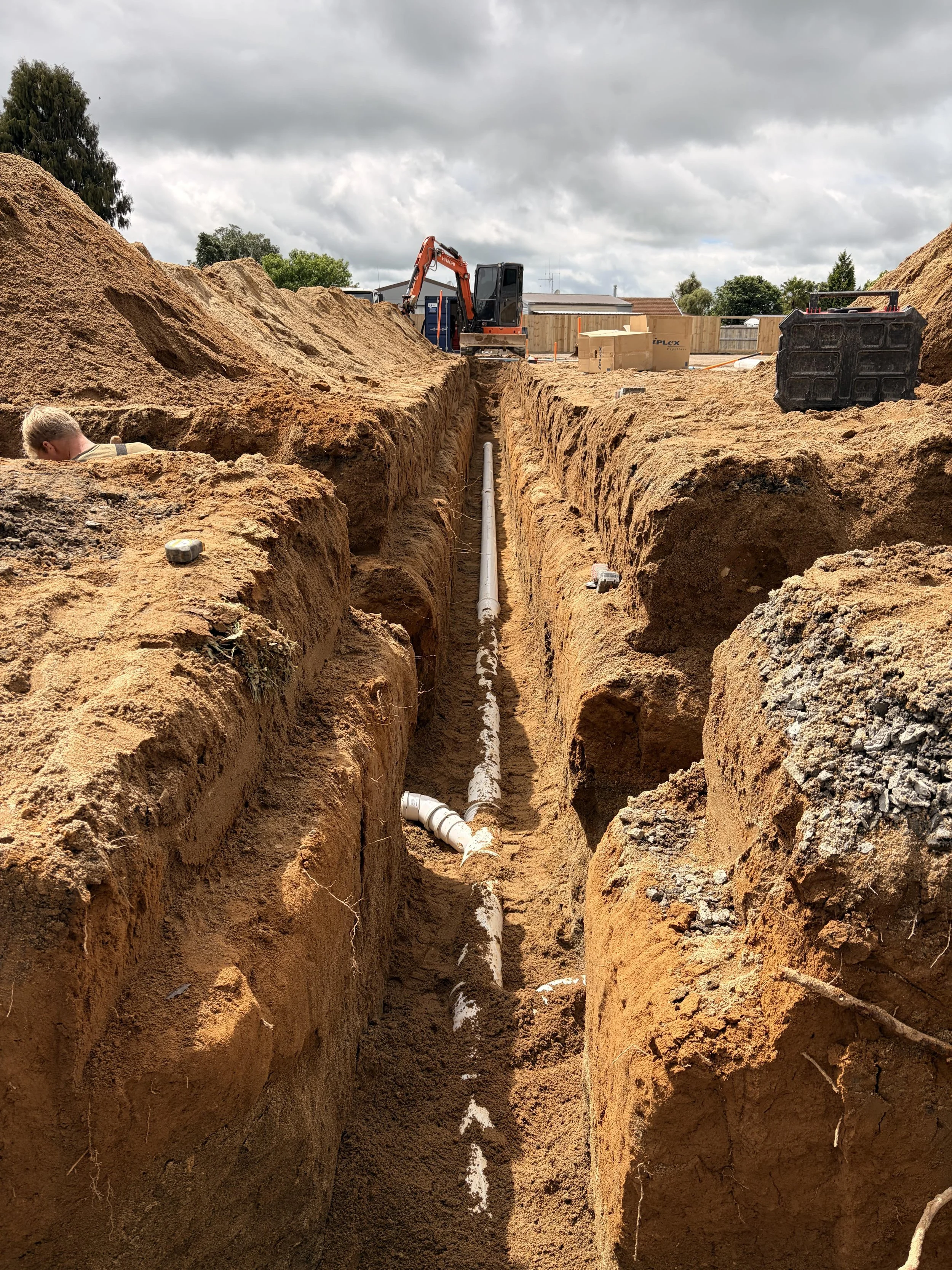 Stormwater drainage system being laid with workers and machinery